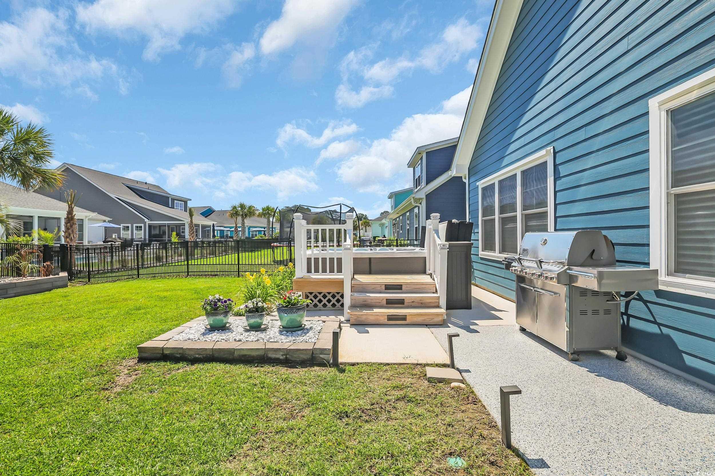 View of yard featuring a deck, a residential view, and a patio area
