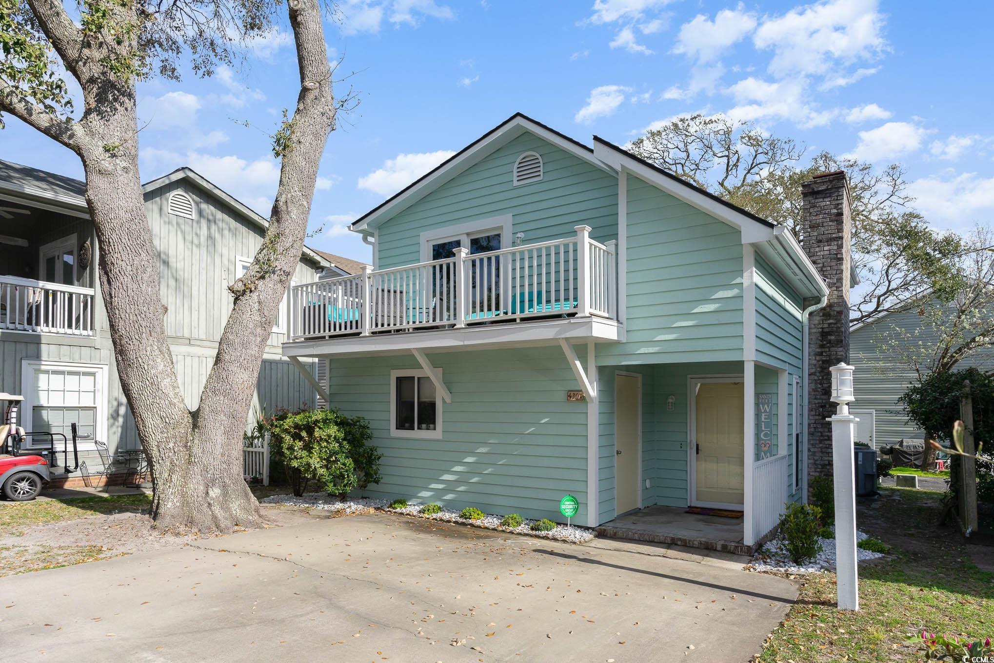 Coastal Elegance Just Steps from the Beach! Welcome to this beautifully remodeled patio home, ideally situated just a block from the sandy shores. Designed with an inviting open floor plan, this residence features a cozy fireplace, perfect for relaxing evenings. The main-level primary suite boasts a walk-in closet, offering both convenience and privacy. Upstairs, you'll find two spacious bedrooms, each with its own private deck, allowing you to soak in the coastal breeze. A full bath completes the second level. Step onto the covered rear deck, thoughtfully designed for shade while enjoying breathtaking ocean views. The main-level deck provides a peaceful, private retreat—ideal for morning coffee or unwinding in the evening. The community pool is just steps from the front door, providing easy access to resort-style relaxation. Plus, this stunning home is only minutes from Barefoot Landing Resort, where you'll enjoy a vibrant mix of exceptional restaurants, live concerts on the lawn, and unique boutique shopping. Don't miss this incredible opportunity to own a slice of coastal paradise!