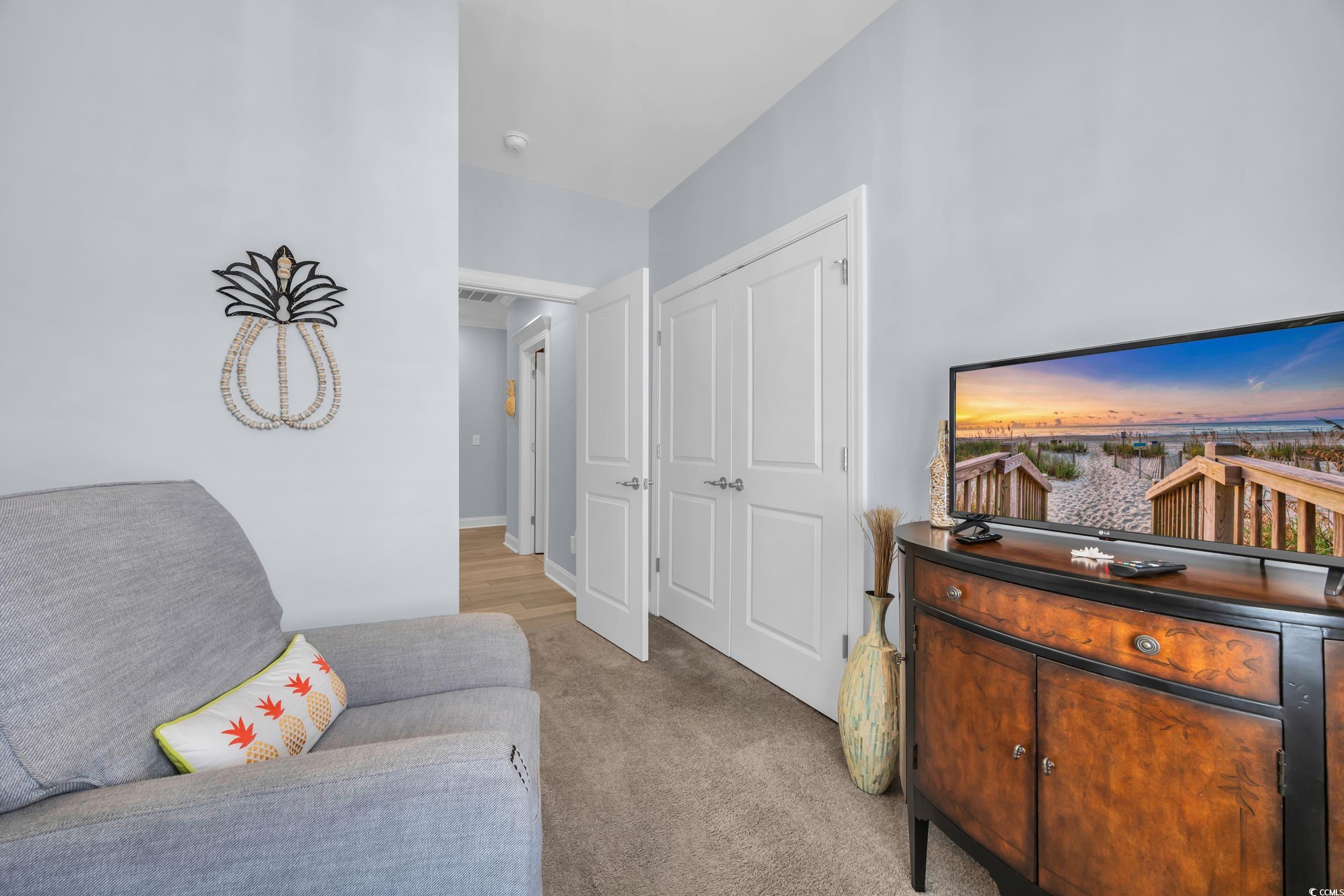 Sitting room featuring light carpet