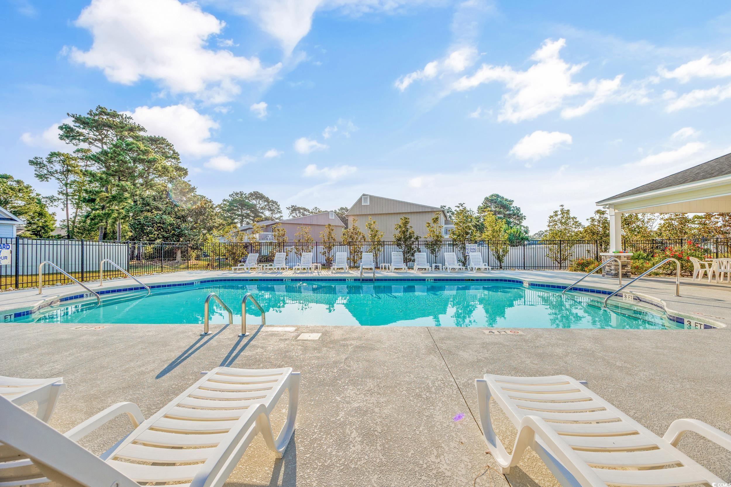 Community pool with a patio