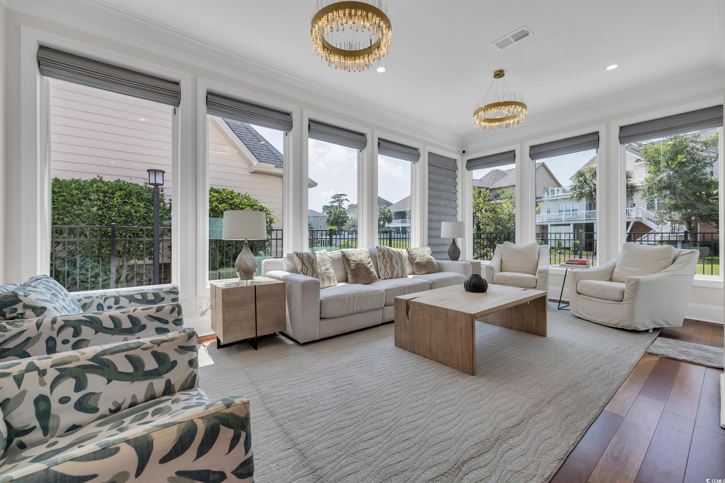 Sunroom featuring a chandelier