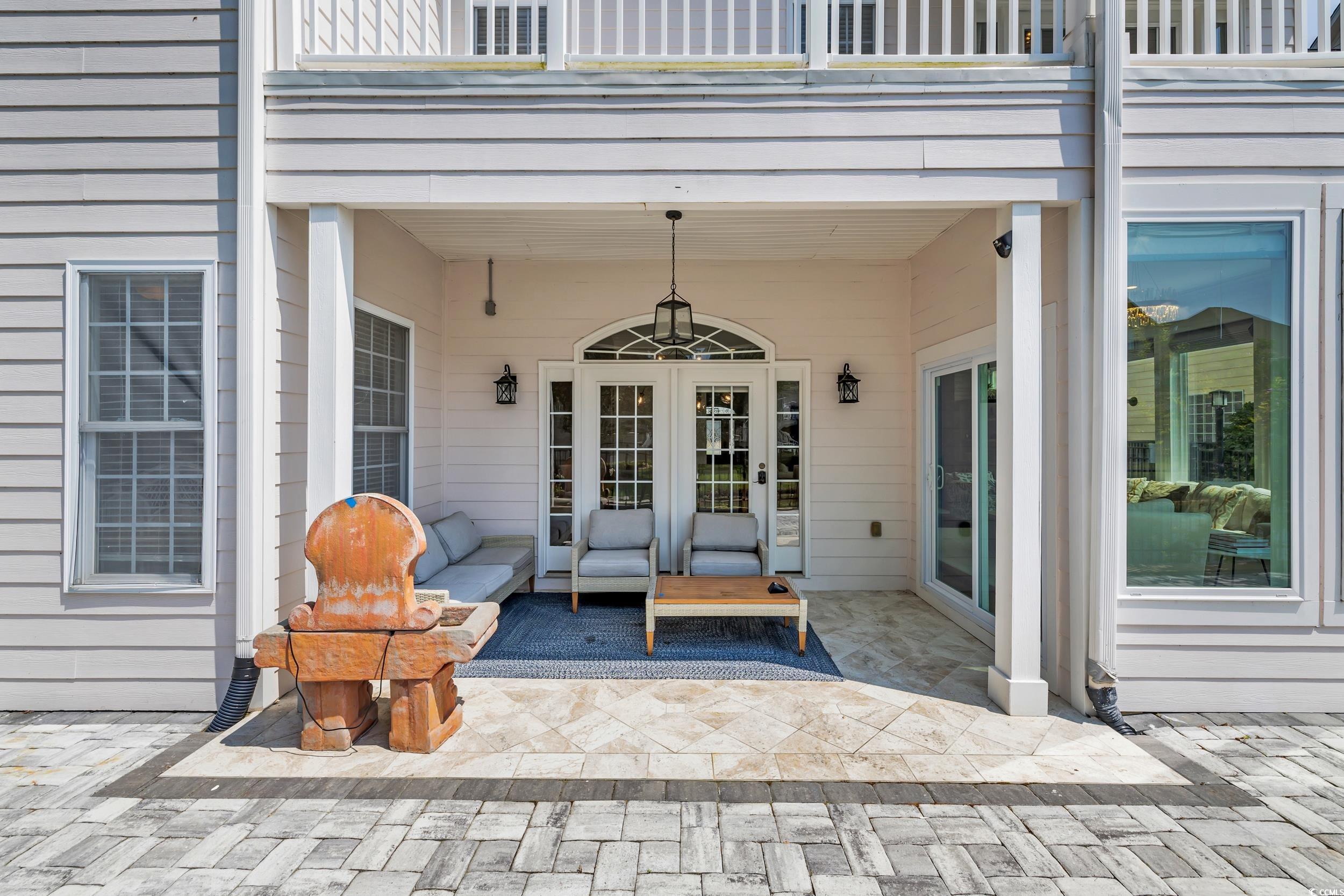 View of patio featuring a balcony, french doors, and an outdoor living space