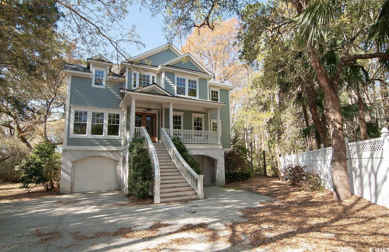 private. beautiful. north litchfield beach. need more? this lovely raised beach house has so much more to offer, including a thoughtful floor plan, numerous transom windows delivering abundant natural light, common area hardwood floors and custom finishing touches and upgrades throughout. gourmet eat-in kitchen boasts granite counters, stainless steel appliances, double oven, gas range and pantry. formal dining room as well as office on main floor. four en suite bedrooms on the top floor. ground level provides covered parking and a bonus room. additional features include elevator to every floor, laundry room with utility sink, screened porch with adjacent sundeck and private backyard with woodland backdrop. several recent improvements include 2 new hvac's, new roof, new top floor flooring and gorgeous new front doors. walk, bike or take the golf cart to the beach. close proximity to brookgreen gardens, huntington beach state park, golf courses, local shops and restaurants. convenient to schools and medical facilities. historic charleston is 80 miles south. myrtle beach is 20 miles north.