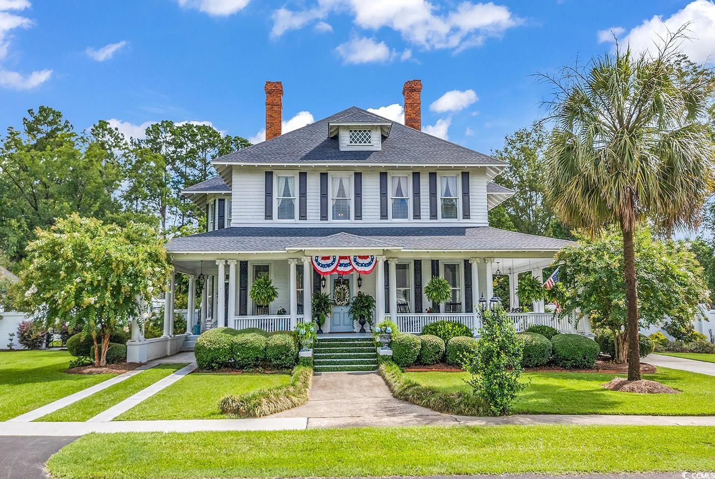 Welcome to the charming historic home in downtown Latta! This beautiful two story 4452 square foot home is ready for a new owner who wants a move in ready historical home with modern amenities! This magnificent colonial residence, constructed in 1900, is a true gem listed on the prestigious National Register of Historic Places. Immerse yourself in the allure of the past while enjoying modern comforts and conveniences. This timeless abode boasts 4 spacious bedrooms and 2.5 bathrooms, providing ample space for your family and guests. As you step inside, you will be captivated by the authenticity of the 123-year-old pine floors, lending a sense of character and warmth to every room.   The allure of history continues with not one, but 7 decorative fireplaces, each showcasing original mantles that have stood the test of time.  Preserving its historic integrity, the home proudly showcases its original windows, allowing an abundance of natural light to grace each room. The intricate moldings throughout the house serve as a testament to the skilled craftsmanship of a bygone era. Prepare to be captivated by the formal parlor, featuring a stunning coffered ceiling, a true work of art that adds elegance and sophistication to the space. It is the perfect place for relaxation and hosting gatherings. For those closer ones, a more intimate family sitting room  is positioned next to a gorgeous original Tiger-Oak mantle. This sitting area links over to the custom kitchen through open the butler’s pantry and is a place for your morning coffee. The kitchen boasts all of the amenities including a walk-in pantry and is ready for entertaining. For those nice evenings the property has front and back covered porches for visiting, reading or simply watching the birds.   From the inviting back, porch step down into a luscious haven of a meticulously managed enclosed garden as you wander to your next entertainment location by the 40,000 gallon salt water pool. Here at the picturesque coastal cabana, one can entertain family and friends for a cook out or watch a football game while the kids swim or play. This open outdoor living room is a gem featuring a gas fireplace, mini fridge and microwave perfect for movie nights!  Step into the kitchen where you will be greeted by exquisite Carrara marble countertops that elevate the aesthetic and add a touch of elegance. The countertops provide ample space for preparing and serving delicious meals, making it a chef's delight.  Enjoy the 40,000-gallon salt-water pool with friends and family. This home also features a carport, detached garage, privacy fence and historic house/barn. The small barn also has plumbing and would be an easy conversion to a mother-in-law suite if needed.   The property also boasts an electric gate with brick fencing for privacy.  Roof is two years old and all bathrooms feature new plumbing and electrical. For those with children, this house is blocks away from Latta Middle and High School making it an easy walk or commute to a premier learning experience.  Go Vikings!  With its exceptional preservation and unique features, this historic home invites you to become part of its illustrious story. This enchanting property boasts a stunning yard filled with a rich tapestry of flora, creating a picturesque and captivating outdoor space. Step into a world of natural beauty and tranquility with an impressive array of plant life that will leave you in awe. As you enter the yard, you will be greeted by the vibrant and delicate blooms of crepe myrtles, tea olives, magnolias, hydrangeas, camellias, azaleas, roses, confederate jasmine, chaste trees and olive trees.  Do not miss the opportunity to own a piece of history while enjoying the comforts of modern living. Schedule a visit today and step into the past with this extraordinary colonial home in downtown Latta, SC.