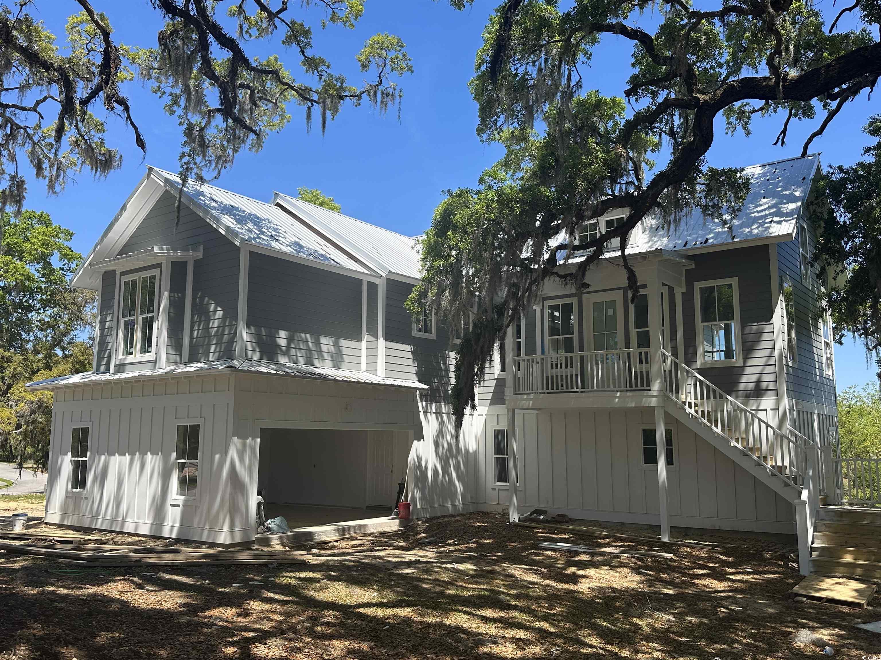 nearly complete and ready to be your new home!  amazing views of winyah bay, live oaks and unbelievable master suite!!  strategically positioned overlooking the winyah bay, this home takes advantage of the spectacular views while escaping being in a flood zone. nestled between two 300 year old heritage live oaks, this transitional 4 bed 3.5 bath has plenty of southern charm. the exterior has many details including metal roof and beams add to its lowcountry appeal.  brushed brass fixtures with a mid century modern flair and frigidaire appliance package make this kitchen a chefs dream.  feel like you are on an endless vacation in the owners suite, with a 14x12 custom walk-in closet with island.  the owners bathroom continues pouring on the charm with beautiful tile and a free floating tub tucked in its own cubby for some relaxation time.  downstairs are 3 bedrooms, two bathrooms, living room/den and a mudroom with laundry area.  the living room will have cathedral ceilings with beams and a porch with amazing views of winyah bay!  this home is constructed to withstand even the strongest storms.  other features include tankless hot water heater, tile showers and lots of parking/storage.  south island plantation is a gated community full of live oaks on winyah bay at the southern end of georgetown.  it is less than 60 miles to historic charleston, sc and 40 miles to myrtle beach.  just a few miles to georgetown's front street with boutique shopping and dining.  this community has a beautiful clubhouse with a fitness center, an outdoor pool and outdoor walking and biking trails!