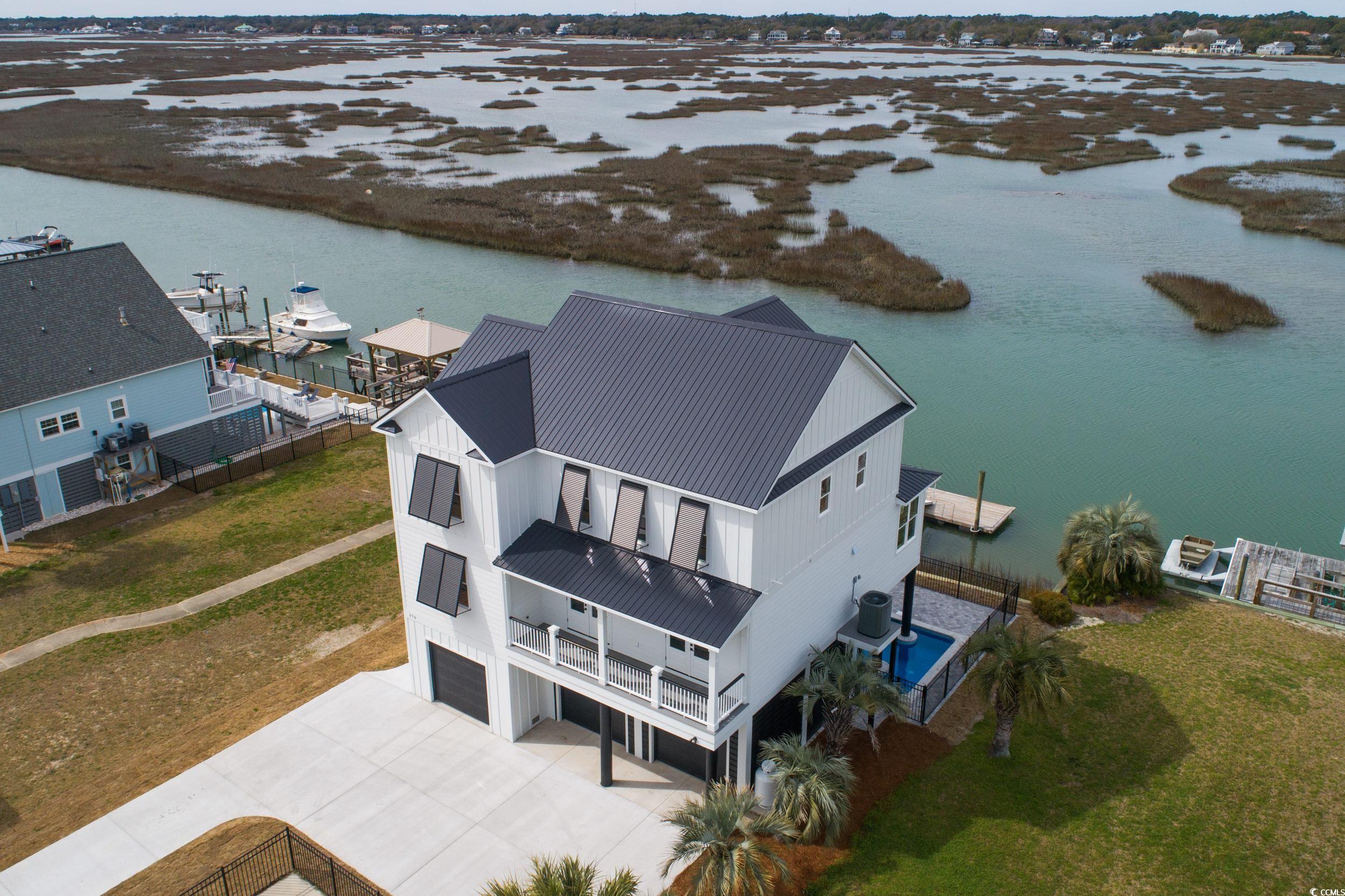 brand new 2440 sq. ft main channel inlet lot 5 bedroom 4 bathroom home with inlet views (from almost every window) and an existing floating dock for your boat... additionally this home will have as standard features pre-stained james hardie plank lapsiding with 15 year wear warranty, timbertech composite decking with pvc railing and balusters for a zero maintenance exterior... interior will have custom 1" wood cabinets in the kitchen and all bathrooms with granite tops in kitchen and all bathrooms as well, luxury vinyl plank flooring installed in all interior floored areas for long sand longevity in this sandy environment, wainscoating/beadboard installed in all common areas for that classic beach look and also to protect the sheetrock from wear and tear from summer rentals, bullnosed/rounded sheetrock, trane hvac units, stainless steel appliances and led downlighting throughout the common areas and finally an elevator and a pool.