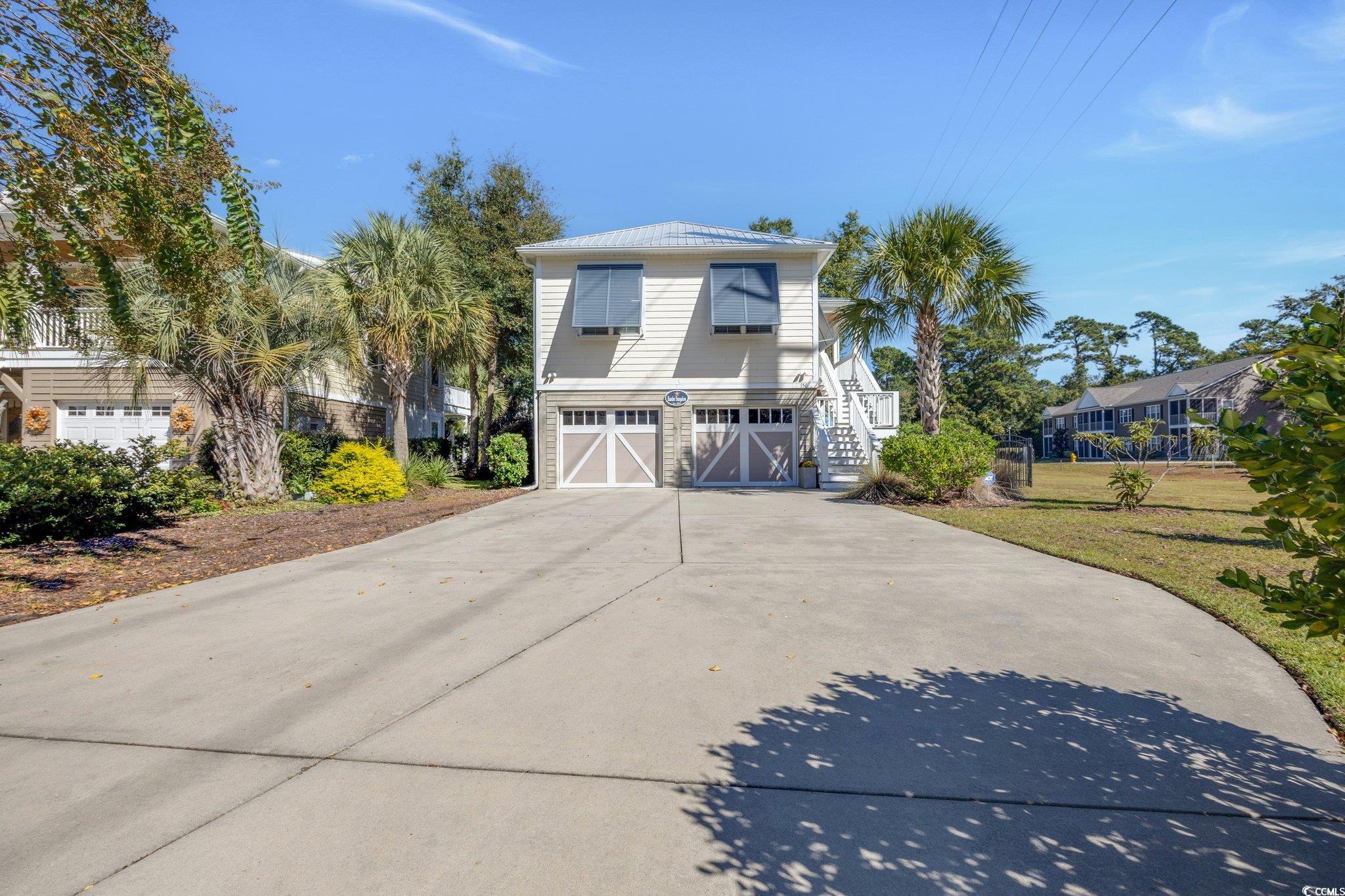 welcome to the atalaya cove community in pawleys island, south carolina. this raised beach-style home features an enclosed garage with ample parking and storage space. 156 harbourreef dr. is a meticulously maintained three-bedroom, 2 1/2 bath residence. the open floor plan boasts exquisite wainscoting accents throughout the home.the kitchen offers generous space for entertaining. the primary bedroom is located on the upper level with an ensuite bathroom with a walk-in shower, while the lower level features two additional bedrooms and a full bath. gently used as a second home and still shows like a model, close to pawleys island and litchfield beaches, golf courses and fine dining.