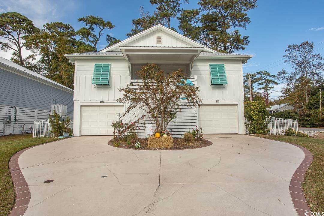 price reduction for this beautiful raised beach house in pawleys sunset just off the south causeway and a golf cart or bike ride over the bridge to the beach.  the location of this 4 bedroom 4 and half bath home says pawleys island lifestyle.  the downstairs area has plenty of room for all your toys.  the screened in living area with easy breeze windows and gas fireplace gives you ample room to entertain after a day at the beach or a cozy fall evening to relax and enjoy some football. this area also includes a storage room for all your tools, there is a half bath and outdoor shower.  up the stairs is a covered front porch and as you enter the home you will be greeted by vaulted ceilings with ceiling fans, an open living area with luxury vinyl plank flooring, kitchen with white staggered cabinets, island, granite countertops and stainless steel appliances.  there are two bedrooms off the main living area on each side of the home with each having its own bath.  the master bedroom has two walk in closets.  the master bath has dual vanities, comfort height toilet, walk in shower and the washer and dryer hookups.  this house features a back deck off the kitchen, a downstairs back patio, tankless hot water heater, smart home panel, irrigation system, sentricon termite control.  the owner has added hurricane panels, overhead steel garage doors, leaf filters, white aluminum fencing and more.  don't miss out on your opportunity to be minutes from fishing, crabbing, kayaking, paddle boarding, the beach and all that pawleys island has to offer. all measurements and square footage are approximate and not guaranteed.  buyers are responsible for verifications.