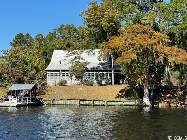absolutely stunning 3br/2.5ba home with beautiful views of the black river in georgetown! this home features heart of pine floors throughout, a large gas fireplace, large sunroom with indoor grill area overlooking the breathtaking views of the river. custom kitchen with stainless steel appliances and a first floor master suite offers large walk in closets,  large tub and shower. the lot has a bulkhead and is almost .76 acre with a covered dock area and a large detached apartment/work shop. perfect man cave or mother/ inlaw apartment. this beautiful country style river home with breathtaking views of the historic deepwater black river is located just 17 miles from quaint georgetown, also a beautiful boat ride to downtown for shopping or dining. this one is truly a must see!  square footage is approximate and not guaranteed. all information is deemed reliable but not guaranteed. buyer is responsible for verification buyer is responsible for verification.