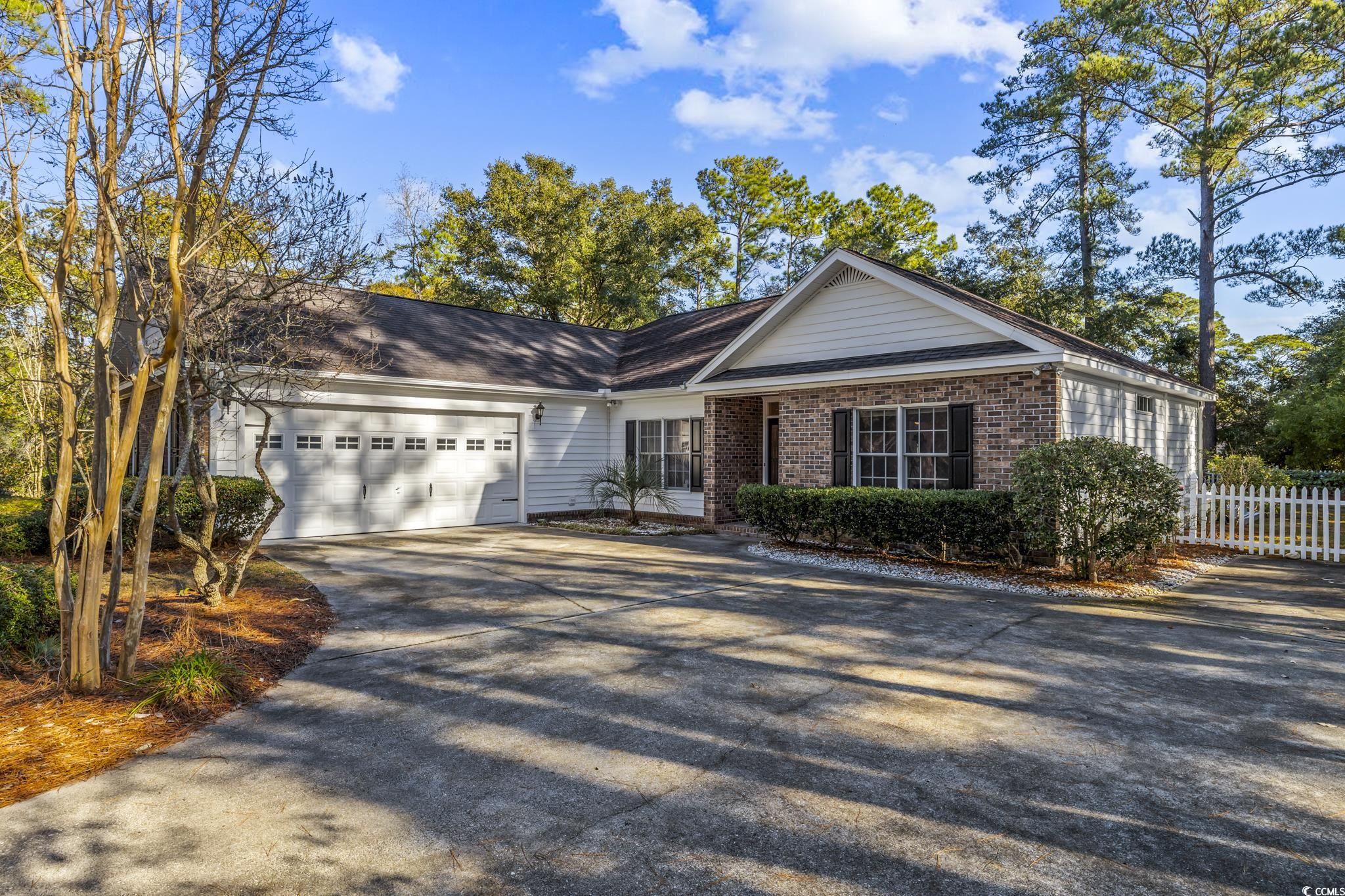 568 Kings River Rd in Hagley Estates. A highly sought after Pawleys Island address, about a mile from the Waccamaw River and public boat launch, close to the beach, True Blue, Caledonia Golf, on a wooded, fenced lot (.41 ac, Azaleas, Gardenias, Tea Olives, Hardwoods and Pines) and best of all the Hagley Estates Homeowners Association is Voluntary! This 3 bed, 2 bath home split bedroom plan is open and bright with a laid back low country charm with living areas all on one level. Kitchen and Dining Area open to the Great Room, vaulted ceilings, two lighted niches for plants or art display, built-in desk with shelves and drawers for storage, vented gas log fireplace with blower to warm you on those chilly Carolina mornings. Kitchen has a Breakfast Bar, stainless appliances, deep, double stainless sinks, solid surface tops, 36” and 42” craftsman style cabinets, adjacent to the 10 x 6 Utility Area (shelving, cabinets and hidden storage for small appliances). From the Great Room you enter the 22 x 13 Carolina Room through double 15-Lite French Doors, featuring four windows open to the back yard and sliding doors on each end that flank open decks (14 x 14 and 14 x 21) with built-in seating, perfect for entertaining guests. Luxurious Owner Suite with Tray Ceiling, crown and access to the 14x21 open deck, double walk-in closets, Master Bath with Whirlpool Tub, custom tile shower with glass tile accent, storage/linen closet, double vanity with solid surface tops and comfort height commodes in both baths. On the opposite side of the home you’ll find 2 Guest Bedrooms (14 x 12 and 14 x 13, remote controlled fans, crown) and shared Guest Bath with upgraded vanity, tub shower combo with transom for natural light. Wait, there’s more. In the backyard there are two detached storage buildings (12 x 8, 10 x 7) offering many possibilities. There is no need to buy bottled water anymore, there is a whole house water filtration system located in one of the Guest Bedroom closets. You’ll be glad to have backup electricity with your Generac Generator powered by two 100 gallon above ground propane tanks (rental). Also, there’s a buried 120 gallon propane tank on the opposite side of the property. And just in case you’re wondering, the answer is YES, there is room for a pool. Courtyard entry 550 square foot garage provides enough room for two larger vehicles. The driveway extension allots room for boat parking. Brick and vinyl low maintenance exterior. New heating and air installed 2021. (Images depicting furniture are virtually staged and are for demonstration purposes only)