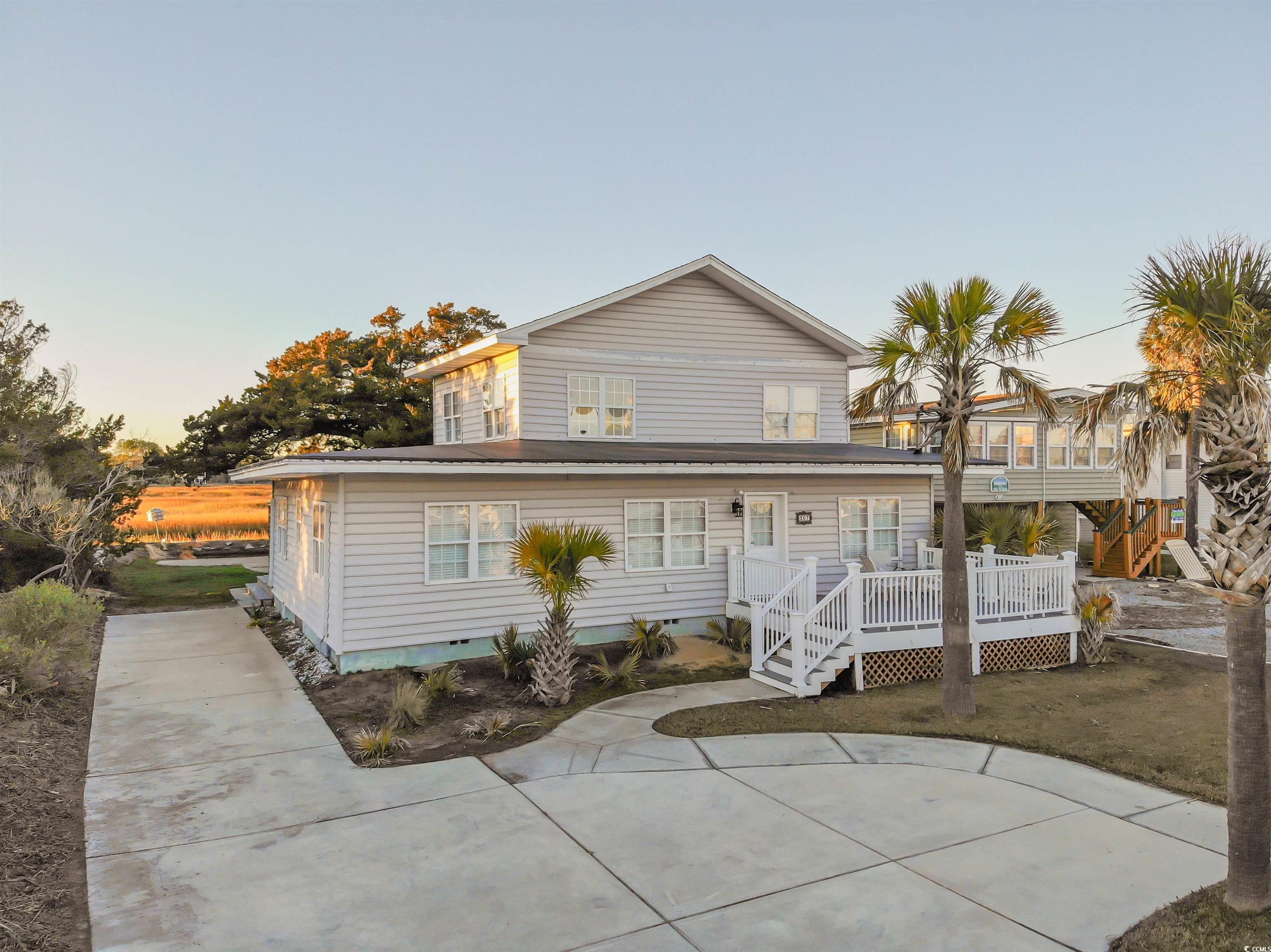 welcome to "cypress cottage" at 207 n. dogwood drive – a captivating beach house nestled just one block away from the pristine shores. this charming property offers a coastal lifestyle on the north end of the picturesque murrells inlet marsh.  embrace the ease of beach living with a mere 2-minute stroll to the sandy shoreline. enjoy the convenience of nearby attractions including the garden city pier, sam's corner, delightful restaurants, quaint gift shops, an inviting ice cream parlor, and lively arcades – all within walking distance.  marvel at the breathtaking backyard views during stunning sunsets, creating an enchanting ambiance. "cypress cottage" is not just a home; it's a versatile gem suitable as a primary residence, a serene second home, a lucrative rental investment, or an all-encompassing property for varied interests.  the entire first floor has been thoughtfully renovated with resilient lvp flooring, pvc waterproof wainscoting, and insulated for optimal comfort. electric rewiring in 2022 ensures modern functionality and safety. recent upgrades within the past six months include new kitchen cabinets, formica countertops, a kitchen sink, faucet, and a hot water heater, offering contemporary convenience and style.  step onto the composite front deck, a 2022 addition, perfect for enjoying coastal breezes and relaxation. each bedroom, living room, and dining area on the first floor boasts new mini-split heating and cooling systems, while the second floor features central heating and cooling. a new condenser in the attic ensures efficient climate control.  additional enhancements include a new driveway in 2020, a roof replacement in 2018, updated plumbing with pvc replacing copper pipes, and a brand-new outdoor shower, enhancing the beachside experience.  this property truly embodies the essence of coastal living, offering something special for everyone. don't miss the opportunity to make this your own slice of paradise.