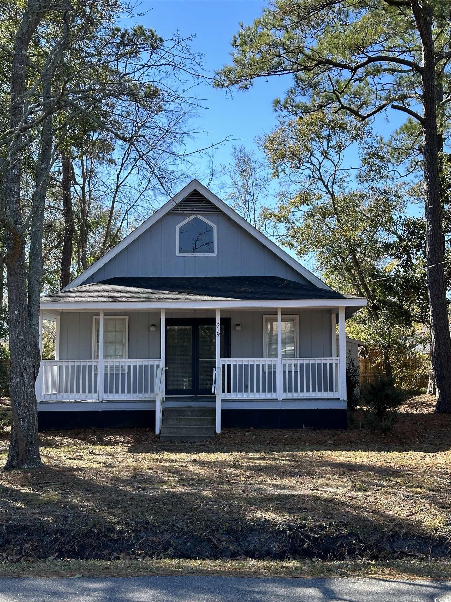 enjoy a short golf cart ride to the beach from this beach bungalow set on a spacious lot. leave the sand outside and enjoy your outdoor shower, two bedrooms downstairs share a full bath. this open concept floor plan has an upstairs loft with 1/2 bath offering a great flex space.