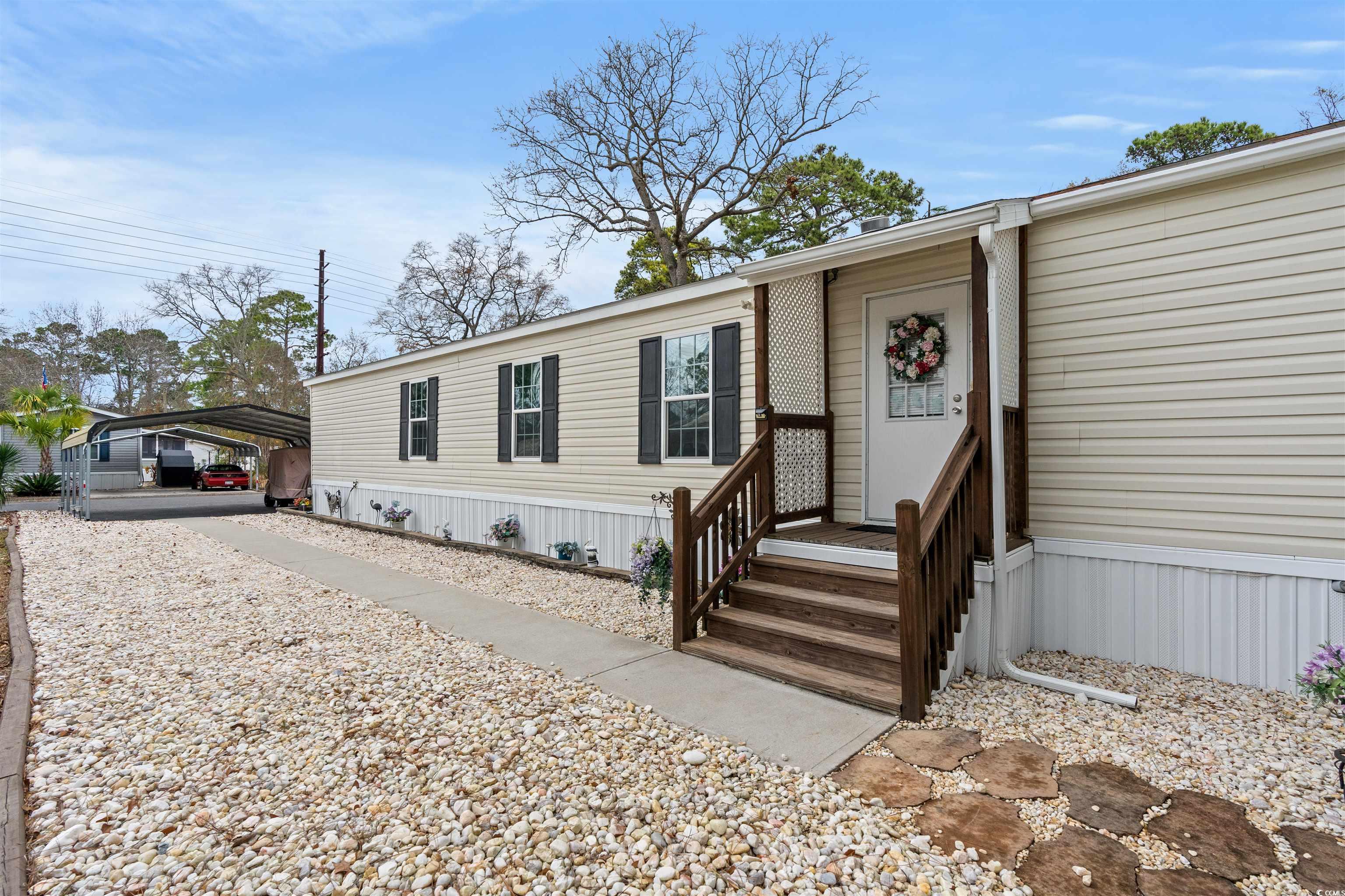 don't miss your opportunity to own this like-new 3 bedroom, 2 bathroom 16x76 mobile home in the quiet community of windjammer village, located in the heart of murrells inlet. this home features a heated/cooled 7x16 carolina room, a detached storage shed with electric, and 2 carports for plenty of covered parking! featuring lvp flooring throughout the entire home, with crown and chair railing, & a ceiling fan in almost every room. the kitchen is equipped with all stainless steel appliances including a 28cubic ft-2 drawer side by side fridge newly added in 2023, and plenty of cabinet and counter space. partially furnished with a couch, loveseat, lazy boy chairs, tv, deck box, window treatments, & 4 rugs. preventative termite & pest control done regularly,  & 3m privacy film has been installed on almost all the windows.  this home is truly move in ready!  not only does this home have so much to offer but the community also includes a pool and clubhouse all within close proximity to the beach, shopping, famous dining on the marsh walk, golf courses and entertainment attractions. whether you are looking for your forever home or a second home near the beach, you won't want to miss this. schedule your showing today!