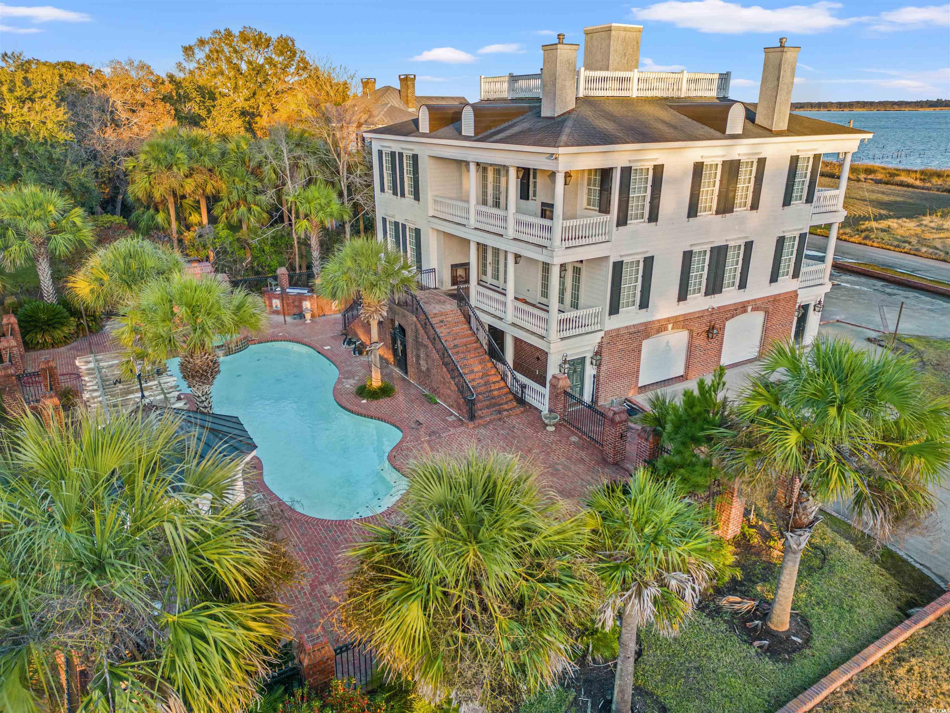 a georgetown jewel that would easily fit in with the mansions that line charleston's downtown battery, this high end, custom built home (designed from a plantation in la)  is the epitome of gracious southern living. with a setting overlooking winyah bay (& including the large waterfront acreage across the street) the home is adjacent to east bay park & downtown boat landing with access to the intercoastal waterway & the atlantic ocean. this beautiful home has just undergone an extensive renovation. custom details abound throughout from palmetto stone over the brick entrances, italian tiles in the backyard kitchen, the carved palmetto & crescent moon chair rail(no longer made due to expense), the sc seal brass medallions adorning the fireplaces and tradd street charleston gas lights throughout. as you walk through the mahogany front door, elegant formal living and dining rooms complete with wainscotting lead to the large family room and kitchen featuring a 60" viking commercial oven with hood, kohler sink with built in steamer, kohler bar sink on large island, viking electric oven, warming drawers, trash compactor, 48" viking refrigerator and fisher pactel built in dishwasher 'drawers'. this floor includes one of the two laundry rooms, powder room with progressive lights & wine room. home features a large master bedroom and bath (which includes one of the nine fireplaces), two more bedrooms, each with their own bath and a study/sitting/4th bedroom. a full size staircase takes you to the attic for storage galore. take the elevator to the rooftop 'widows walk' for a panoramic view of the park, winyah bay & hobcaw barony to enjoy bay breezes under starry skies. the spacious cherry paneled elevator travels from the ground level to rooftop for easy access to all floors. on the ground level, you will find a garage that has openings on both ends, bottom foyer entry, 2nd downstairs laundry, an extra large bathroom for pool and patio dinner guests, and more storage. the backyard oasis includes pool with a waterfall, gazebo and expansive outdoor kitchen for entertaining al fresco. pool and hot tub can be heated if purchaser desires to add heater.  home also features commercial caterpillar generator in case of power outages, inside and outside speakers and sprinkler system. plantation shutters and hurricane shutters stay with home. because georgetown is a waterfront town , the streets around the home have intermittent tidal flooding which occasionally impacts the yard . however, the home has not flooded.  the waterfront lot directly across from the home on winyah bay, which is included in the sale, is the site of the old ferry that traveled to waverly mills to transport travelers to pawleys island. remnants of the pier are still visible. downtown georgetown's shopping, restaurants and harborwalk are just blocks away, the beaches of pawleys island 12 miles, myrtle beach 30 miles and charleston 60 miles to the south. video has been provided with listing to showcase this fine home.