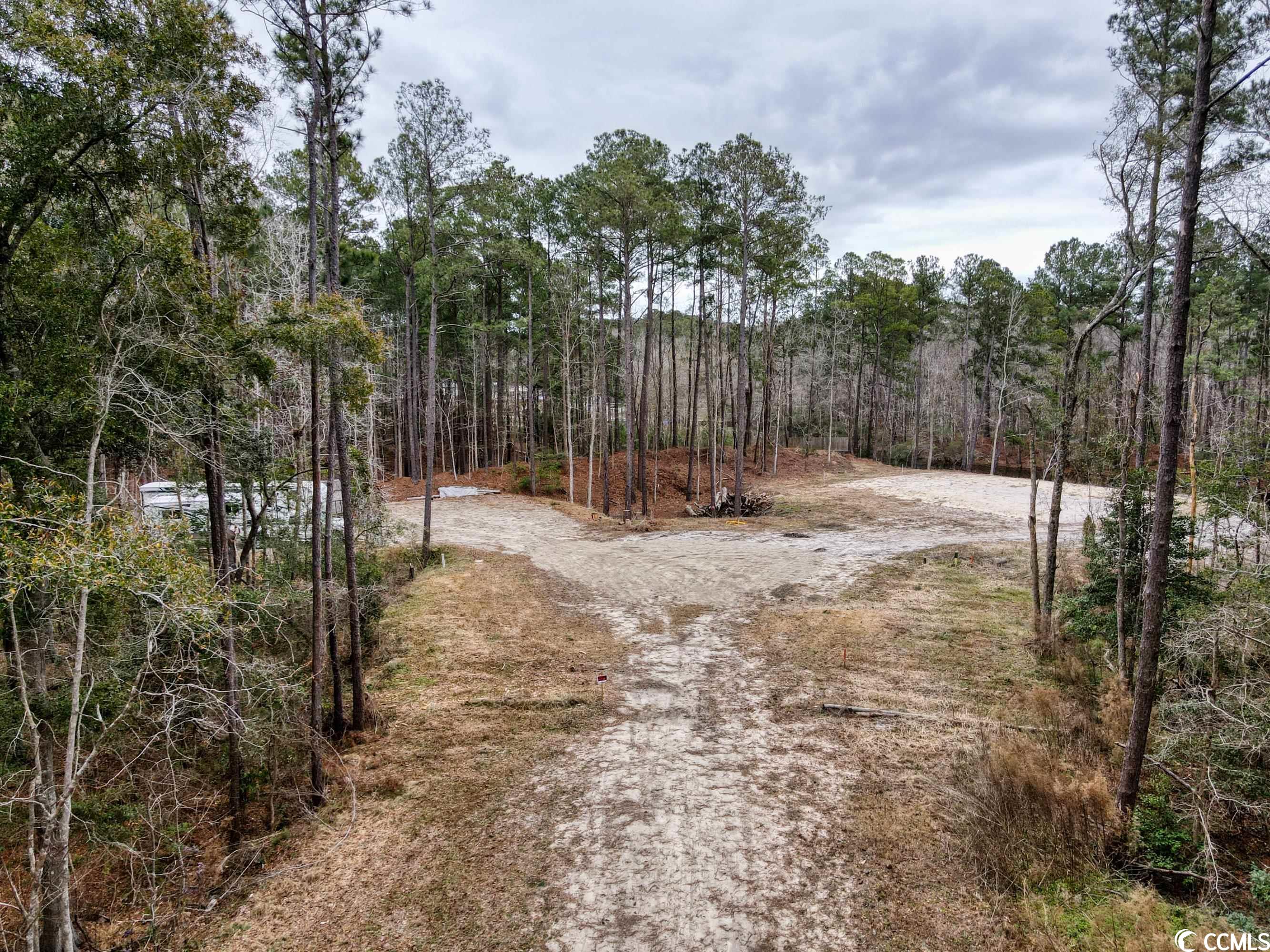 very private over 1-acre with no hoa.  the property is in a flood zone however the seller and his partner have owned it since 2016 and had no flooding from the storms during their ownership. building pad is 75 front 57 on sides.  made of good dirt.  pad sites at about 15'5" high.  with a 4-block high crawl under the house.  30 x 30 shop area built with root mat.  owner had lots 17 and 18 combined to an over one-acre lot only needing one grinder pump.  gsws will allow that with toilet in shop.  power is at the end of the road. fenced 2,300 sq. ft of storage area with a lifetime 8 x 20 shed in it.  fence only 3-years old.  zoned for modular or stick built only, no trailers.  very private lot surrounded by canal on two sides.