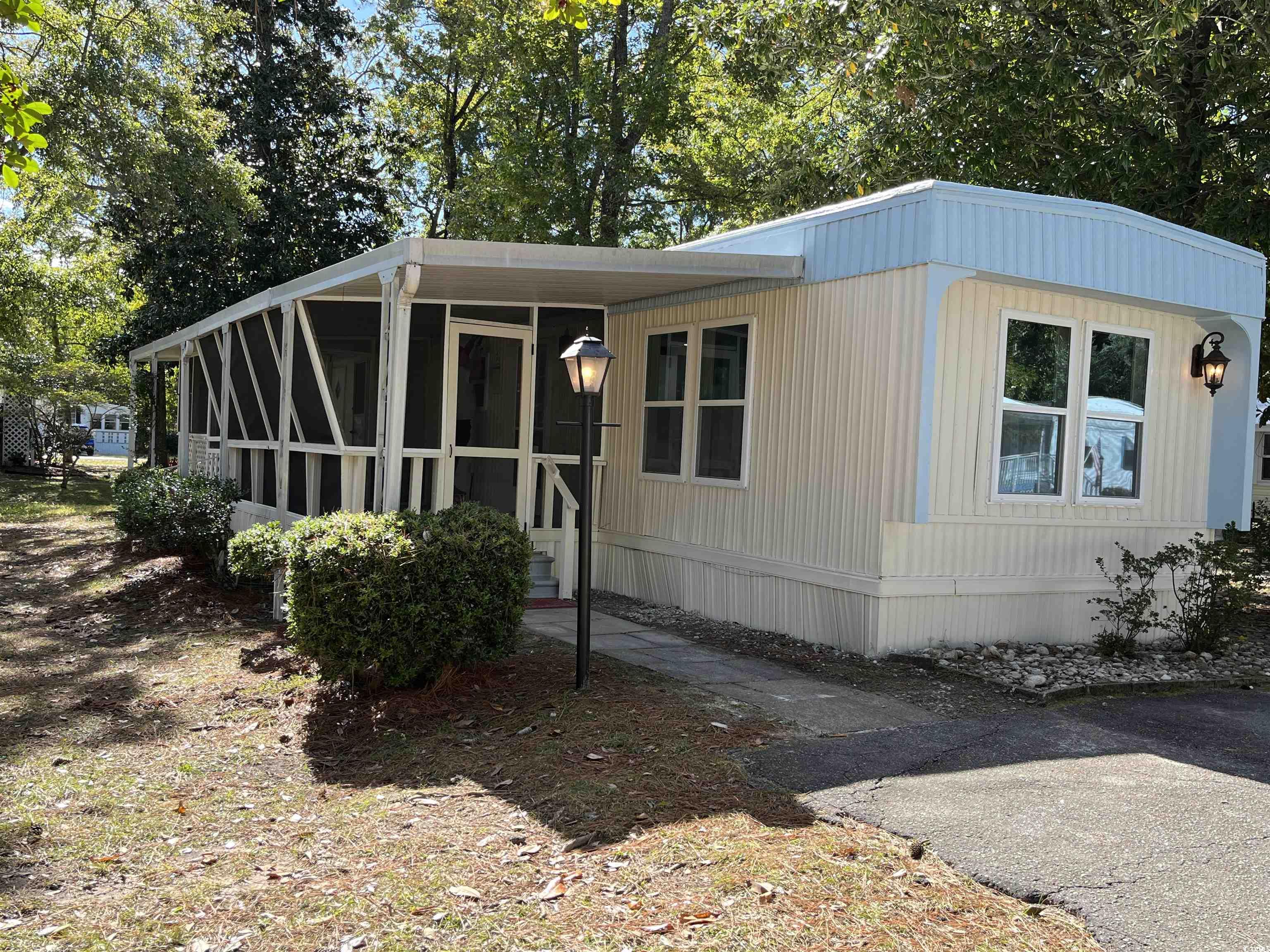 check out this charming two-bedroom, one-bath manufactured home nestled in a serene 55+ community just a short golf cart ride to the beach. this cozy beach cottage boasts a second bedroom complete with a separate sitting area, perfect for transforming into your own private sitting area. this room also has a private separate entrance for your guests to come and go privately. this completely renovated home offers new hvac, new hotwater heater, new stainless steel appliances, new kitchen cabinets with granite counters, new lvp flooring, new roof, new windows, fresh neutral paint, new double sink vanity, walk in shower. enjoy the best of beachside living in this affordable and comfortable home, offering both relaxation and convenience in a vibrant 55+ community. don't miss the opportunity to make this seaside oasis your own! owner is a licensed sc realtor.
