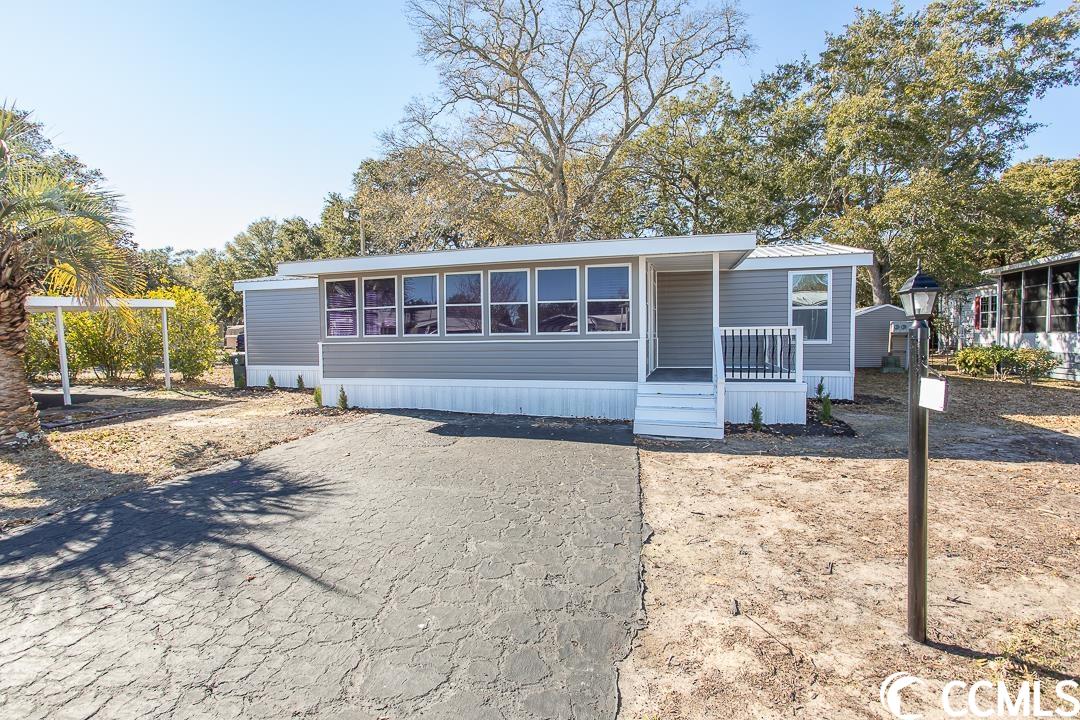 upon arrival, you'll be greeted by the convenience of two blacktop driveways, providing ample space for all your vehicles, with one featuring a convenient carport. the front deck catches the eye with its stunning railing, elegantly accented with black aluminum strips, adding a touch of sophistication to the home's exterior.this beautifully renovated manufactured home features a charming carolina room adorned with shiplap walls. enjoy the abundance of natural light through new windows complementing the brand-new lvp flooring throughout. enhanced with new lighting, the spacious family room boasts charming b-board accents. the kitchen showcases all-new stainless-steel appliances, a pantry, and a generously sized dining area with pendant lighting over the breakfast bar. some walls are accentuated with b-board detailing, adding to the home's character.conveniently located off the kitchen area is a spacious closet for ample storage. the large primary bedroom offers a walk-in closet and an oversized ensuite bathroom with double sinks and a tub-shower combo. on the opposite side of the home, you'll find two nicely sized guest bedrooms, each with its own walk-in closet, accompanied by a guest bathroom. step outside the back door to discover a delightful screened-in porch, perfect for relaxation. additionally, a large shed provides extra storage space. the home is further enhanced with a new metal roof, updated water lines, and new vinyl underpinning, ensuring both aesthetic appeal and functionality."