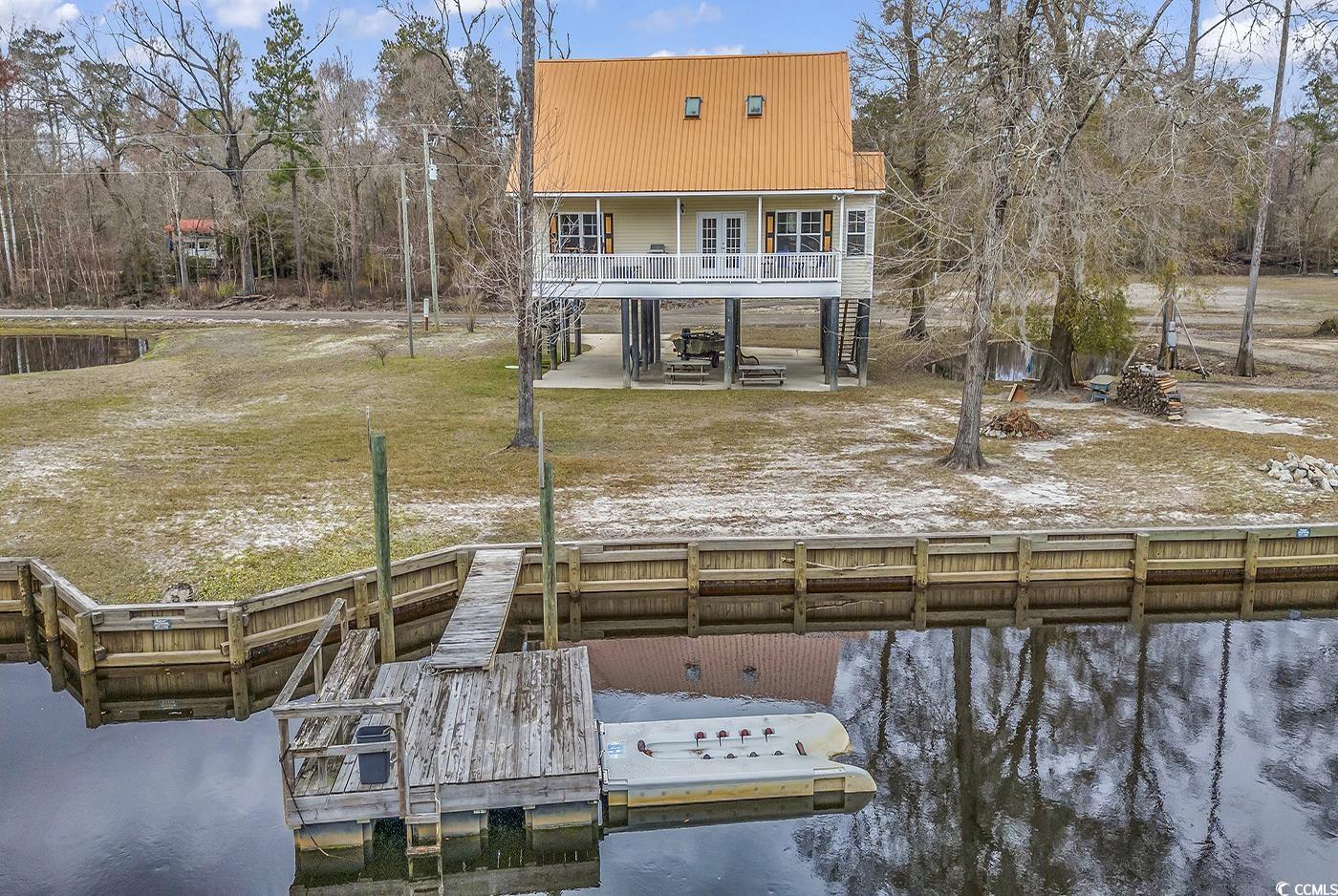 experience the best of both worlds with this tranquil, quiet lakefront home, just a short drive away from the stunning beaches of the grand strand. this riverfront home, a rare gem off highway 90 outside conway, s.c., awaits your presence. nestled on a spacious lot adorned with beautiful cypress trees, the breathtaking views of the waccamaw river surround you. embrace a plethora of activities on your 0.33-acre lot – from having a campfire under the clear open sky for stargazing, to sitting on your floating dock, fishing, swimming, or enjoying a cup of coffee on the expansive back porch overlooking the river. with ample parking for your boat and toys, and being free from hoa restrictions, you have the freedom to make the most of your property.  inside, the home provides abundant space for relishing your riverfront living experience. the master suite, located on the first floor, boasts a large walk-in closet and a spacious private bath. another bedroom and full bath are also conveniently situated on the main floor. upstairs, a versatile loft area, currently used as a bedroom, offers endless possibilities. the laundry room, equipped with fairly new washer and dryer that will convey, is conveniently located off the kitchen area. granite countertops adorn both the kitchen and bathrooms, adding a touch of elegance. don't miss out on the opportunity to seize this chance to own a stunning piece of paradise along the waccamaw river.