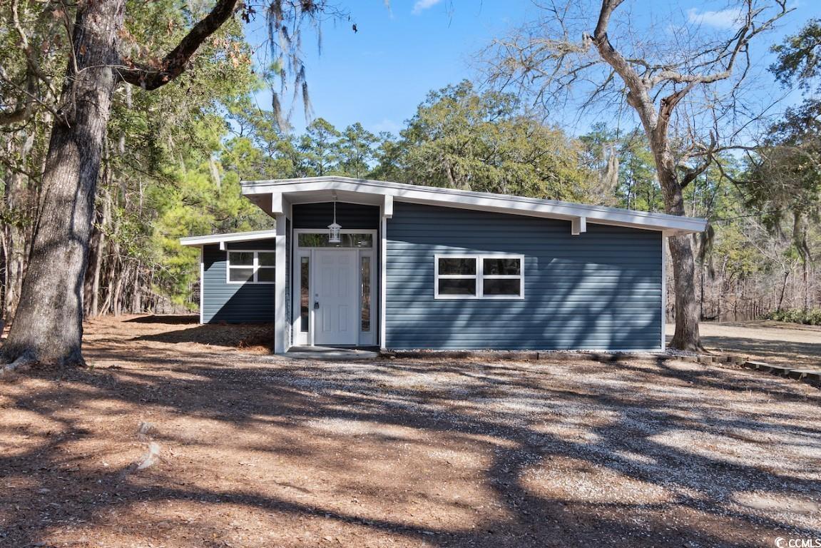 don't miss this rare opportunity to own this 4 bedroom 2 bathroom home on over an acre of land with a private boat ramp on the waccamaw river! this home has been completely renovated to include all lvp flooring in every room, along with upgraded fixtures, lighting, windows, doors, you name it! the kitchen is equipped with all stainless steel appliances, granite countertops, a work island with a breakfast bar, built in cabinetry to make a spacious pantry, and is perfectly combined with the main living areas which offer an entire wall of windows to allow for beautiful river views from every direction. each bedroom includes a ceiling fan, plenty of closet space, and easy access to a bathroom, while the master also includes his/hers closets and private master bath with double sink vanities and a huge tiled walk in shower. a detached shed makes a great workshop or extra storage space, and the huge lot allows for plenty of room to build & expand. with no hoa, the options are endless! spend your days on the river and put your boat in the water from the comfort of your own home, or relax on the huge back deck surrounded by mature oak trees. this home is perfectly close to all of the grand strand's famous shopping, dining, & entertainment including conway's riverwalk, and near the area's schools, grocery stores, and more. schedule your showing today!