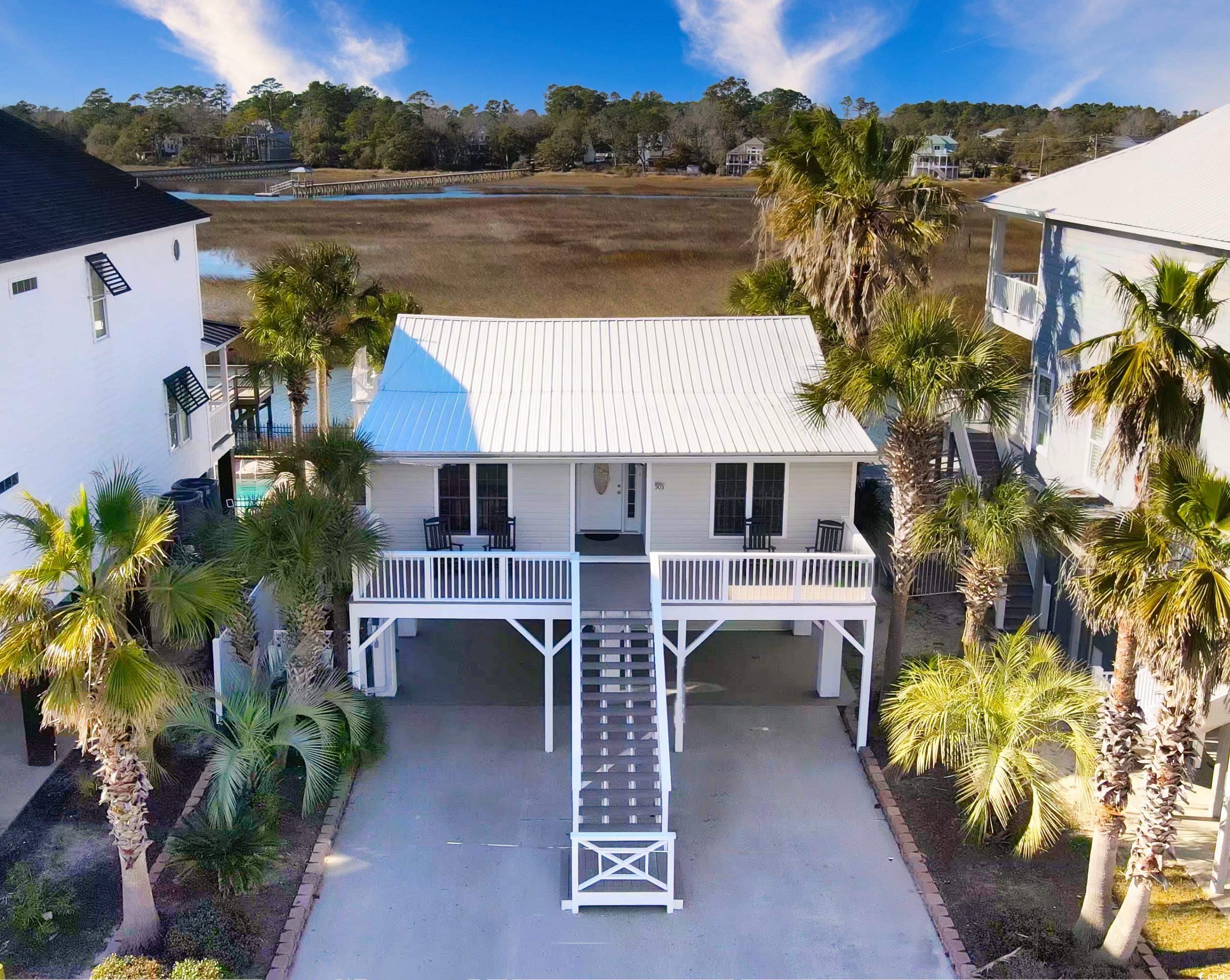 503 n dogwood drive is a six-bedroom, three-bath marsh front home featuring spectacular views and sunsets. just steps after entering, you will be drawn to the floor to ceiling energy efficient windows featuring a 180º view of the marsh. it feels as if the outside is one with the inside as pelicans, herons, and egrets play in the inlet.  a true bird watcher's delight. this comfortable home offers a bright and airy updated kitchen open to the sun room. bamboo flooring and lvp flooring throughout the 2nd level. just off the sun room is a grilling porch and also the best spot to catch the sunsets. there are four bedrooms and two baths upstairs. downstairs offers an independent apartment with two bedrooms and one full bathroom.  the owners added 4' pvc bead board with foam insulation behind it and tile floors throughout the first level. this property has been maintained and updated like no other property in the area. the opportunities are endless with the option to use as a primary home, secondary beach getaway, or vacation rental! under the protection of the covered porch, enjoy the built-in picnic table, grilling, and relaxing. there is a platform to add your very own hot tub or jacuzzi. the marsh front gunite pool makes it hard to remember the beach is just down the street! the owners have taken meticulous steps to maintain the outdoor features of this property by adding a commercial grade seawall, a 12" thick pool wall, raised the pool 18", and used polymer grout on concrete for the pool deck.  and don't forget to check out the waterfall feature in the pool. the sea wall has electrical rough in for a future dock. inlet paradise is walking distance or quick golf cart ride to the beach! kayaking, boating, fishing, crabbing, swimming, the opportunities are endless.  this home has so many features to love - ask your realtor for the list of special features and be sure to check out the walking video tour of this property!