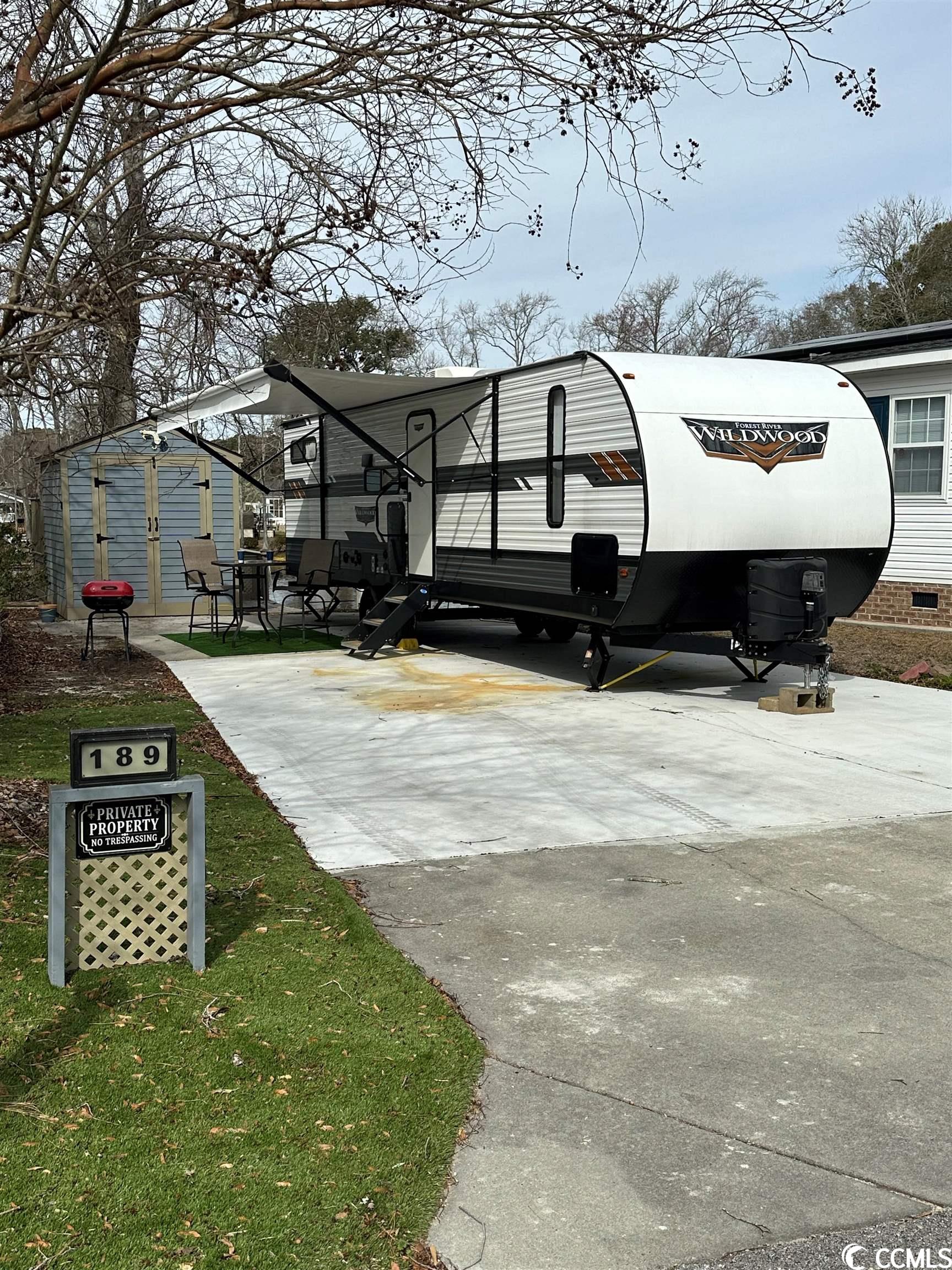 located in myrtle beach rv resort. this lot has a custom-built storage building with a built on private deck facing the pond. this gated community has 2 pools, hot tub, children's pool, community center, basketball courts, playground, 2 ponds, pickle ball and a putt putt course.  the community allows long and short-term rentals and the low hoa includes water and sewer, cable/wi-fi, lawn maintenance and trash pickup. and don't forget you can golf cart ride to the beach. rv on lot can be purchased separately.