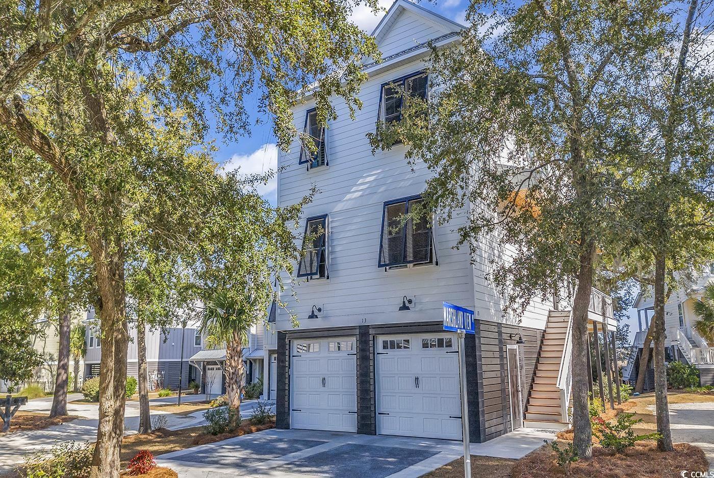 welcome to your coastal paradise at 13 marshland view way.  this like-new residence located in the heart of pawleys island offers marshland views, easy access to pristine beaches, and is the perfect blend of comfort, convenience, and natural beauty.  the open concept floorplan provides a spacious living area that is perfect for entertaining guests or simply enjoying a nice quiet evening at home.  enjoy the coastal breeze on your private deck overlooking the marsh.  this three bedroom, two and a half bath home, is well-appointed with luxury vinyl flooring throughout, beautiful granite countertops, tankless water heater, stainless-steel appliances, bahama shutters, elevator and much more.  owners suite offers a large walk-in custom closet and a fantastic oversized shower.  elevator provides convenient access to all floors.  the raised beach home (with epoxy floors in the garage) provides plenty of space underneath the house to enjoy the outdoors or time with friends and family, as well as a suitable storage room for all your beach or outdoor toys and equipment.  sizable backyard affords opportunity for a fence on marsh side of the home.  embrace the laid-back lifestyle of pawleys island by making this your new home and take advantage of its prime location near renowned golf courses, white sandy beaches, and charming local shops and restaurants.  embark on water adventures by kayaking or paddleboarding through the winding marshes. nature lovers will find themselves in awe of the rich biodiversity that surrounds pawleys island.  located just 70 miles north of historic charleston, sc and 20 miles south of myrtle beach gives you access to everything you need and want.