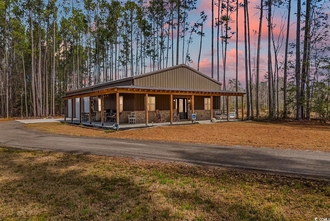 BARNDOMINIUM LOVERS! This is your chance to purchase a rare gem in Horry County. This 40x80x12 barndominium is built and ready for its new owners. It sits on a comfortable 12+ acre lot, and over 800 feet from the highway nestled into the pines, and located safely beside the Pitch Landing fire station. The home offer 4 bedrooms, two full bathrooms, and a half bath located inside the shop portion of the building. There are three 10x10 garage doors to the shop, as well as an exit door to the outside. There is also a detached 20x24 metal shop on concrete slab with two 8x10 garage doors. Inside the home offers two pantry’s, stainless steel appliances, solid surface counter tops, and a beautiful brick fireplace.  The laundry room is located inside the massive master closet. The 64-gun safe inside the master closet conveys with the sale as well, as the rooms were built around it. There is so much to see here. There is over 1,000 square foot of wrap around porch, a fire land surrounding the property, and even a sandbox for the kids to play in while you work in the workshop. You will be 6 minutes to downtown Conway, 25 minutes to the City of Myrtle Beach, and only 35 minutes to the Historic City of Georgetown.