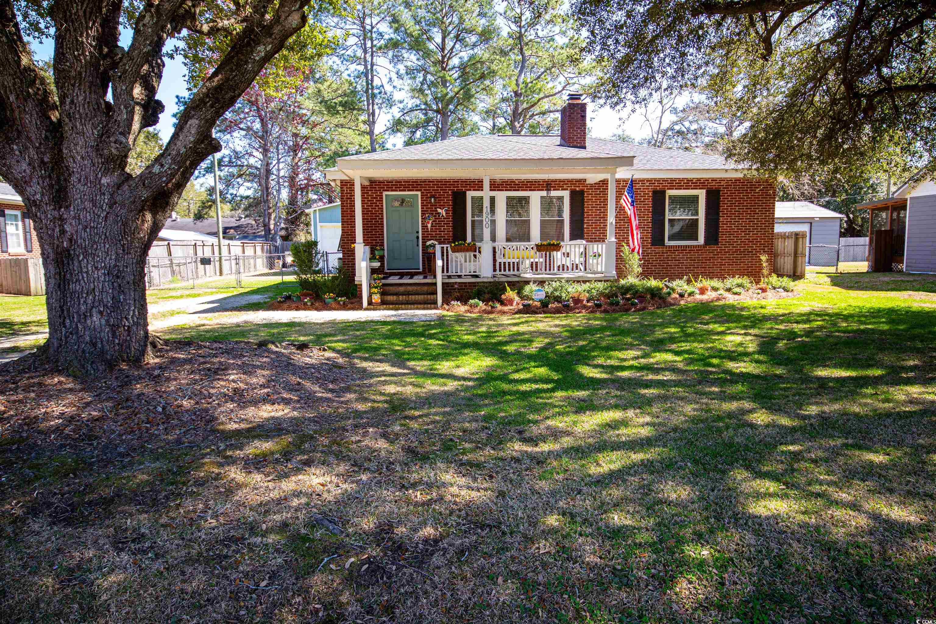 cute remodeled bungalow style home here in the kensington area of historic georgetown, south carolina - 1900 jasper street.  all brick three bedroom, one bath home that was thoughtfully restored in 2018 including roof, crawl space encapsulation, laminate floors throughout, neutral paint colors and so much more!  outside there is a spacious covered front porch overlooking the yard shaded by a tremendous live oak, fenced back yard with patio area, new bahama shutters, and a large detached garage offering tons of storage and workshop space.  the great room/dining area has a large picture window and fireplace with classic dental molding and opens into the kitchen area with new white cabinets, shelving, new stainless ge appliances, and new full size stacked washer / dryer.  the bathroom has a custom vanity with dual bowl sinks, decorative tile floors and subway tile in the tub/shower combination.  this home is tastefully decorated and exudes a calm and welcoming feeling.  be sure to make an appointment to see this cozy home! short drive to georgetown’s waterfront harbor walk with wonderful restaurants, shopping, and fresh seafood vendors. close to numerous boat landings, twelve miles from pawleys island and a located on the hammock coast half way between charleston and myrtle beach.  *buyer responsible for verifying square footage and hoa details.