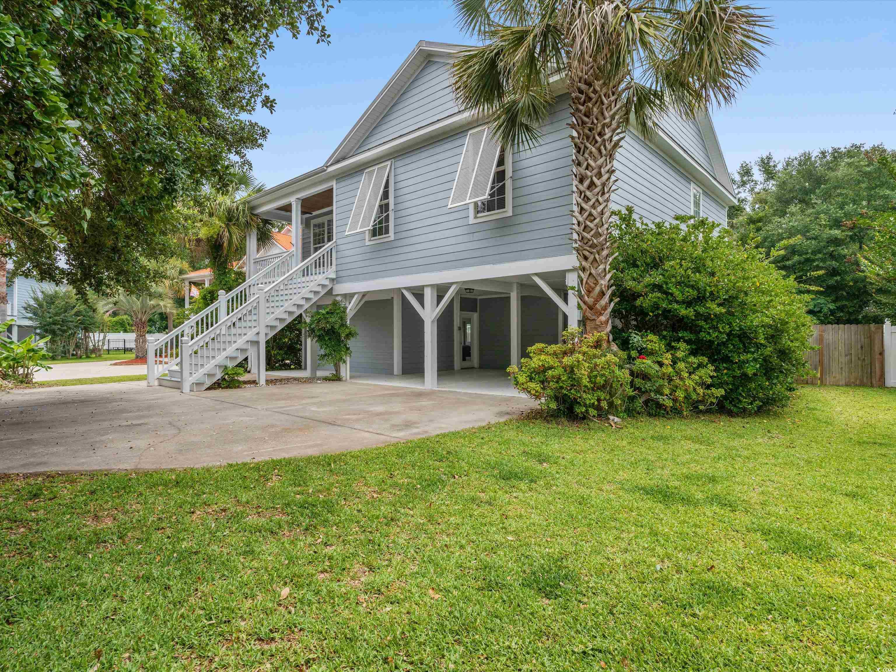 check out this lovely raised beach house in the heart of murrells inlet. just a short walk or golf cart ride to all the restaurants and the marshwalk and just minutes to garden city beach or huntington state park. this home is a 4 bedroom 3 bath with two master suites (one on the main floor and one on the ground level). the home has had extensive cosmetic upgrades since 2018 and features cool gray and blue tones with white, black and natural wood accents. the kitchen was completely remodeled in 2020 and features stainless steel appliances, quartz countertops, stacked shaker style cabinets, a cypress shiplap backsplash and a black shiplap island with black composite farm style sink. new lvp was installed throughout the upstairs, except bathrooms in 2020 as well. all bathrooms feature tile floors. the downstairs master bedroom floors are engineered hardwood and were replaced in 2018. the downstairs master bedroom also features an upgraded trim package featuring white shiplap contrasted with charcoal blue accent walls. there is direct access to a screened porch and the back yard from the master bedroom. entire exterior of home and shed were repainted in december of 2021 range and over the range microwave were replaced in late 2022. dishwasher was replaced in 2018. new water heater was installed in 2023. the fenced backyard features a large shed with cabinetry currently configured for use as a workshop and home gym. there is also a raised bed garden area. range, microwave, dishwasher and front load washer and dryer convey. the two refrigerators and remaining tvs do not convey. square footage is approximate and not guaranteed. buyer is responsible for verification. seller is licensed sc real estate agent.