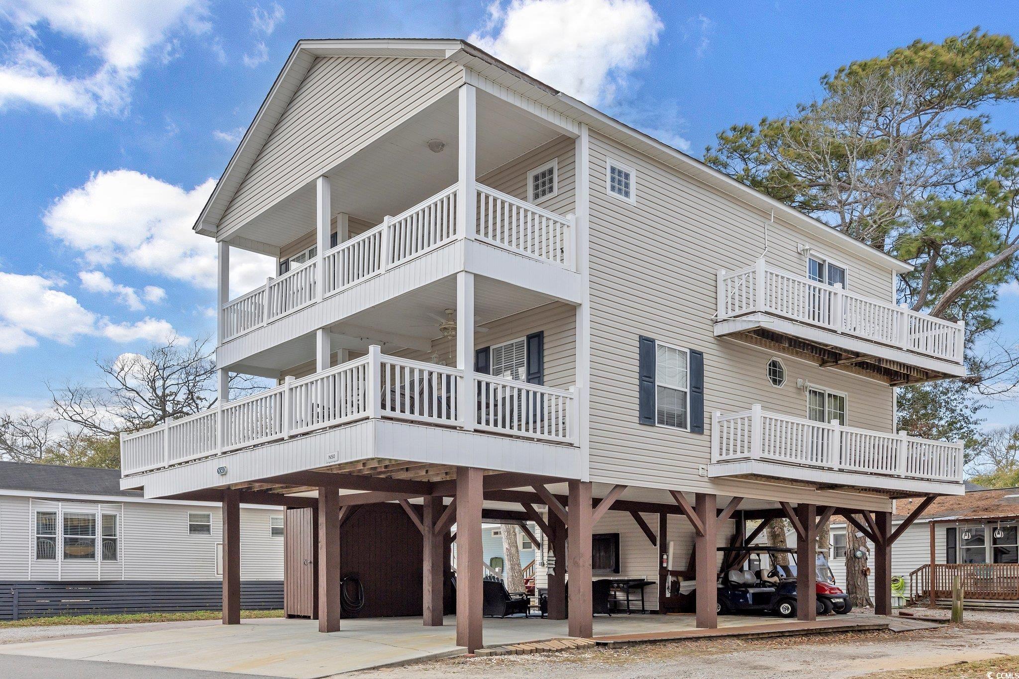 grab your swimsuit and come indulge in all that ocean lakes has to offer along the grand strand. all you need is your personal items with this furnished home. this open 4 bedroom, 3.5 bath home is ready to make memories for years to come. featuring large spacious bedrooms, with a master on each floor, you also have 4 decks around the house for sunning, hanging out and enjoying the shade and breeze year round. the home at n50 also features many recent upgrades like new furniture, upgraded lvp flooring throughout, new main decking and fresh paint inside. there is plenty of parking underneath the home for you and your guest, a recently added entertainment area with seating and tv and also a storage garage for your beach toys and extras. located centrally in ocean lakes, you can access the store, snack shack and even the arcade and water park all within walking distance if you choose. did we mention lazy river, water slides, indoor pool, putt-putt, and recreation center with daily activities? the ocean is a straight shot from either end of the street. hop on the golf cart or your bicycle to go explore and take in the beauty of ocean lakes and enjoy activities and events around the year. this home would be great to live in full time, or even used as a second home and rental property. the openness of the main floor makes for great game nights and socializing with your friends and family. the fully stocked kitchen is ready for all occasions and hosting meals for many. there is no hoa in ocean lakes, but there is a yearly lot lease paid half in january and half in july. ocean lakes offers 24 hour security, gated entry, a mile of beach front, activities year round for all ages and amenities for everyone. come see for yourself all that ocean lakes has to offer and compliment this well designed home. schedule your showing today!