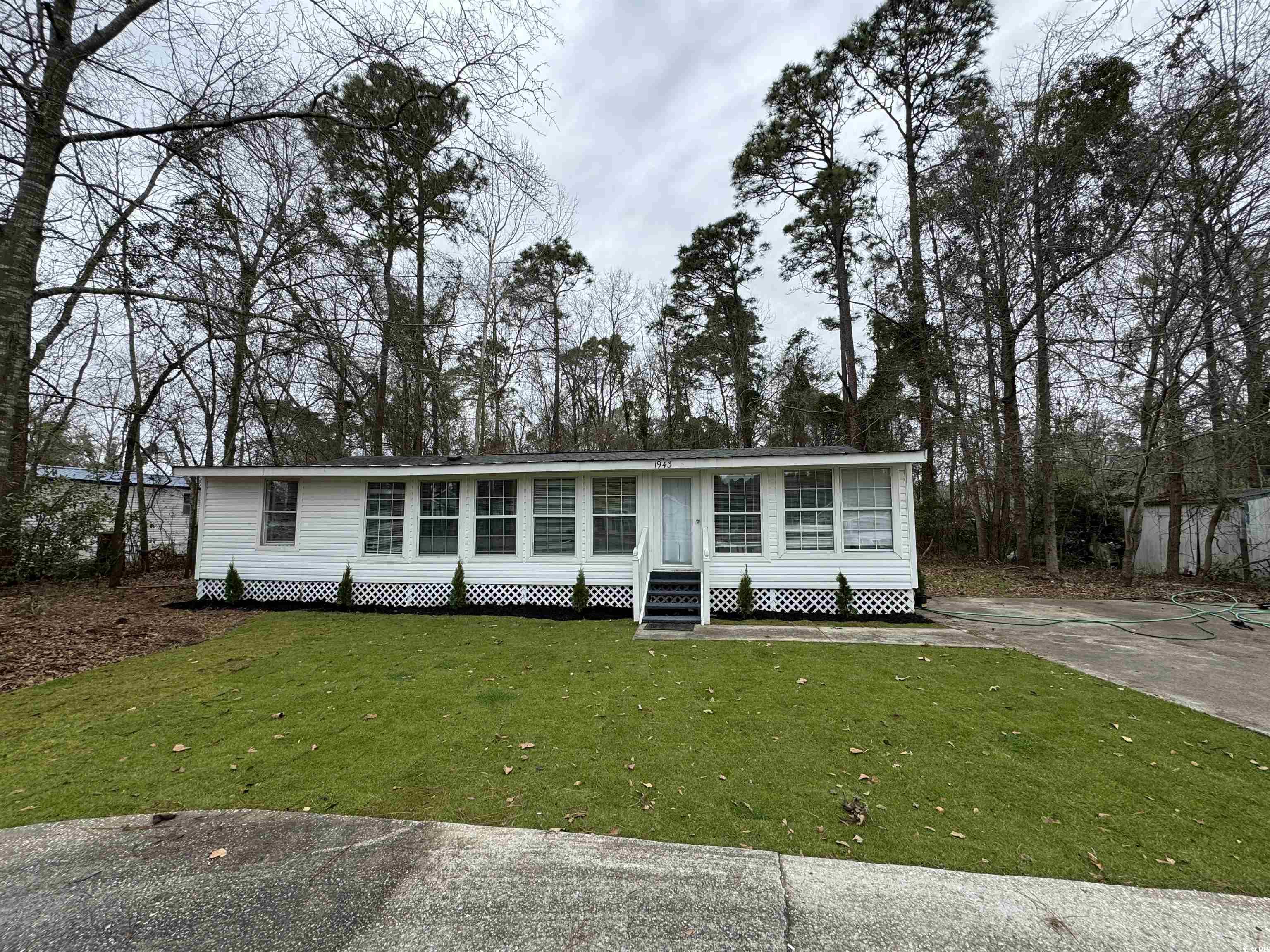 located close to downtown conway - this nicely "flipped" single wide features beautiful front yard, large enclosed front porch (34'x7'6"), split bedroom floor plan, outdoor storage building, new paint, new flooring and new bath. .36 acre lot and no hoa