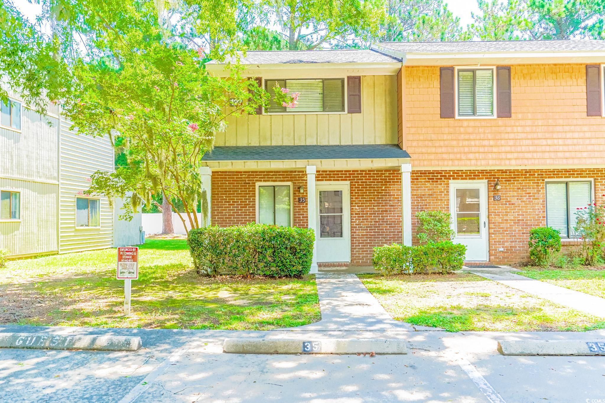 welcome to this charming two-story townhome in the heart of pawleys island called chapel creek villas, offering a distinguished brick front accent that adds charm to the exterior. this end unit provides extra natural sunlight and features a welcoming front porch area with columns to enhance the facade. inside you will find a large eat-in kitchen space and open to the family room.  freshly painted throughout, new flooring and quartz counter tops. the wood burning brick fireplace is an added feature where you can enjoy the warmth of a fire or escape through the sliding glass doors to the back enclosed porch/ bonus room area for a little privacy. available large storage room with shelving that could hold all your beach stuff or your bicycles for that afternoon bike rides. located a short distance to the beach, shopping, grocery stores and the best restaurants around.