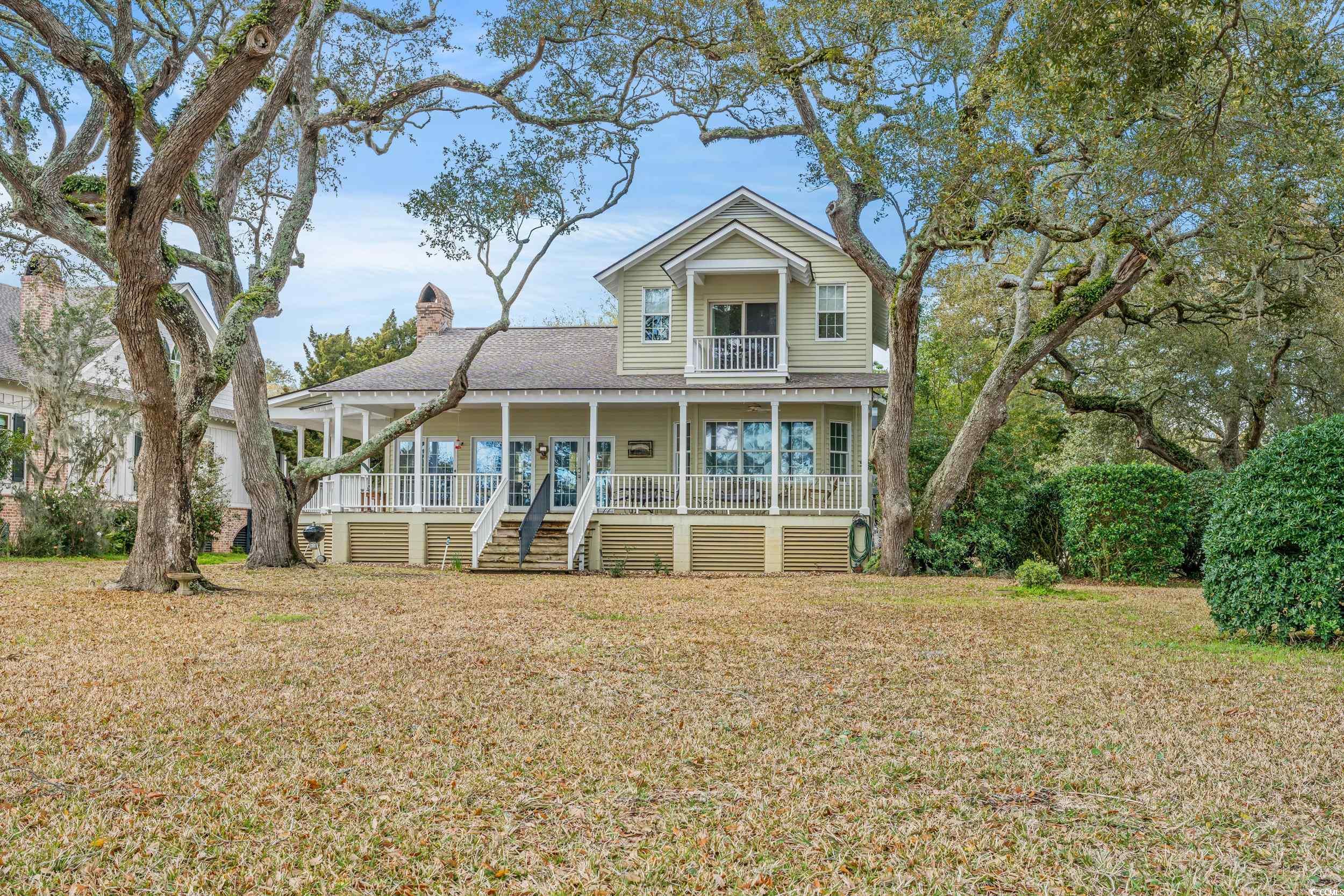 welcome to 319 sunnyside ave, located in the historic sunnyside plantation of murrells inlet, south carolina.  this property is the epitome of coastal southern living. soft bermuda grass, mossy oak trees, cool ocean breeze, and endless breathtaking views of parsonage creek, murrells inlet.  being deepwater navigable, this private dock and channel front connect you to the murrells inlet marshwalk, garden city point, and atlantic ocean jetties.  the property is divided into two detached living spaces. in the front is a traditional low country home, featuring three bedrooms, a renovated kitchen, and a spacious living room. all with beautiful views of the oak trees swaying with the backdrop of the inlet. the other is host to a 3 bedroom setup with kitchen and bath. think mother-in-law suite. this setup is located above a large garage with plenty of storage for your boat, kayaks, and fishing rods.  these types of properties just do not come up for sale often, as this timeless neighborhood rarely leaves family trees.  come join the quiet, peaceful, historic community located in the fishing capital of south carolina.