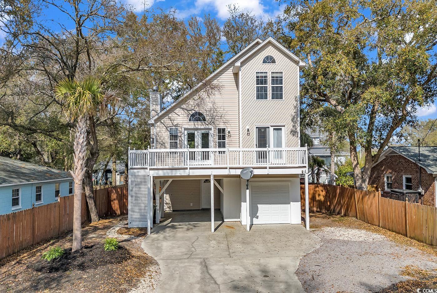 golf cart to the beach and not in a flood zone! 4th bedroom is on ground level with secondary separate entrance. easily a guest or in law suite!   wood burning fireplace is the anchor for family room with vaulted ceilings.  spacious master suite on main living level opens to front deck and features a private bath and large walk in closet. expansive front and rear decks to catch ocean breezes and grilling out or relaxing with family and friends. enclosed garage workshop is ideal for golf cart storage or fun projects and work space.  large fenced in yard with additional storage shed is ideal space should you decide to add a pool!. new lvt flooring on first floor living space, quartz countertops in kitchen and a new roof in 2023!