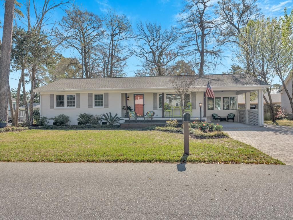 charming coastal retreat just a short distance from the beach!  welcome to your seaside sanctuary! if you've been looking for the beach house of your dreams, this is it! nestled merely one half mile from the beach in a quiet neighborhood, this 3 bedroom, 2 bath, all brick home, is meticulously maintained and offers the perfect blend of coastal living and modern comfort.  as you step inside, you'll be greeted by an inviting open floor plan bathed in natural light, creating an airy and spacious atmosphere. the living area features wood floors throughout with corian countertops, stainless steel appliances, ample cabinet space and exhaust hood in the kitchen and built-in cabinets in the living room. shiplap board provides accent on walls throughout the home. the bathrooms feature tile walls in guest bath and primary bath.  an attached all-glass sunroom with an electric fireplace provides an opportunity to enjoy the outside without being affected by the weather. if you prefer to take in the warmth of the sun you can do so on the concrete patio or adjacent wood deck in the private backyard or you may like enjoying the neighborhood from the front porch.  outside, you'll find a well-landscaped yard and large paver-stone driveway providing ample off-street parking.  conveniently located just moments from the beach and a short distance to all the great dining, shopping and entertainment amenities the grand strand area has to offer, this home presents an unparalleled opportunity to embrace the coveted coastal lifestyle. spend your days sunbathing on the sand, surfing the waves, or exploring the vibrant local area. all this an no hoa!!  don't miss your chance to make this coastal dream home yours. schedule a showing today and start living the beach lifestyle you've always envisioned!  act quickly as this one won't last long on the market!  all information provided deemed reliable but guaranteed.  buyer/buyer agent should verify all information.