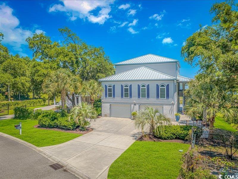 imagine waking up to this stunning view every day and knowing that there will never be houses built to spoil the beauty of the marsh and ocean views. located in inlet marsh, this custom built house backs onto the huntington beach preserve and is situated within walking distance to huntington beach state park, is just minutes away from the marshwalk and the waccawacce marina, and is within close proximity to myrtle beach, pawleys island, and only 90 minutes to charleston.   designed with entertaining in mind, the gourmet kitchen has new stainless steel appliances, two islands, a large pantry with an extra refrigerator, and a commercial “sonic-style” ice-maker that conveys. the primary suite is on the main floor offering 10' ceilings and 8' tall doors and featuring a tray ceiling. this large bedroom has two primary bathrooms (one which has an ada accessible roll-in shower with built in seat) and two walk-in closets. an additional full bathroom is on the main floor. conveniently, laundry areas are located on the main floor and on the guest floor. the guest floor features has 9’ ceilings and a sitting area with epic marsh views that are beyond compare  on this floor are four bedrooms, each with their own walk-in closets and bathrooms.  outside is a main level screened-in porch and over 500sqft of deck space with unobstructed 180° views of the inlet and atlantic ocean. relax in the salt water pool or enjoy time by the fire pit  on the pavered deck while you enjoy the ocean breeze.   the home was designed to last, and meets the miami-dade hurricane standards with hurricane-rated windows and exterior doors. the garage walls are constructed with blocks filled with rebar and concrete. the outside walls of the home were built with 2x6’s rather than the standard 2x4’s and both walls and attic areas have spray insulation. the oversized garage has the space for at least three cars and plenty of storage in the main garage area which boasts approximately 1800sqft. there is additional parking space in the driveway  for several more vehicles or even your boat. you will never have need for a storage unit again as an additional area at back of the garage boasts a 40’x 12’ storage area complete with built in shelves.   the house features a brand new 22kw whole house generator. also of note is a propane gas tankless hot water heater, stove, dryers, and upper deck grill and garage connections. the house has new luxury waterproof laminate in the great room, new carpet in the primary bedroom, and most of the home has been freshly painted. completing the house is a seamless metal roof, hardie board siding, and an elevator which accesses all floors.    truly, this is the place to host friends and family, or use as an investment property as there are no restrictions for short or long term rentals. definitely, a must see!