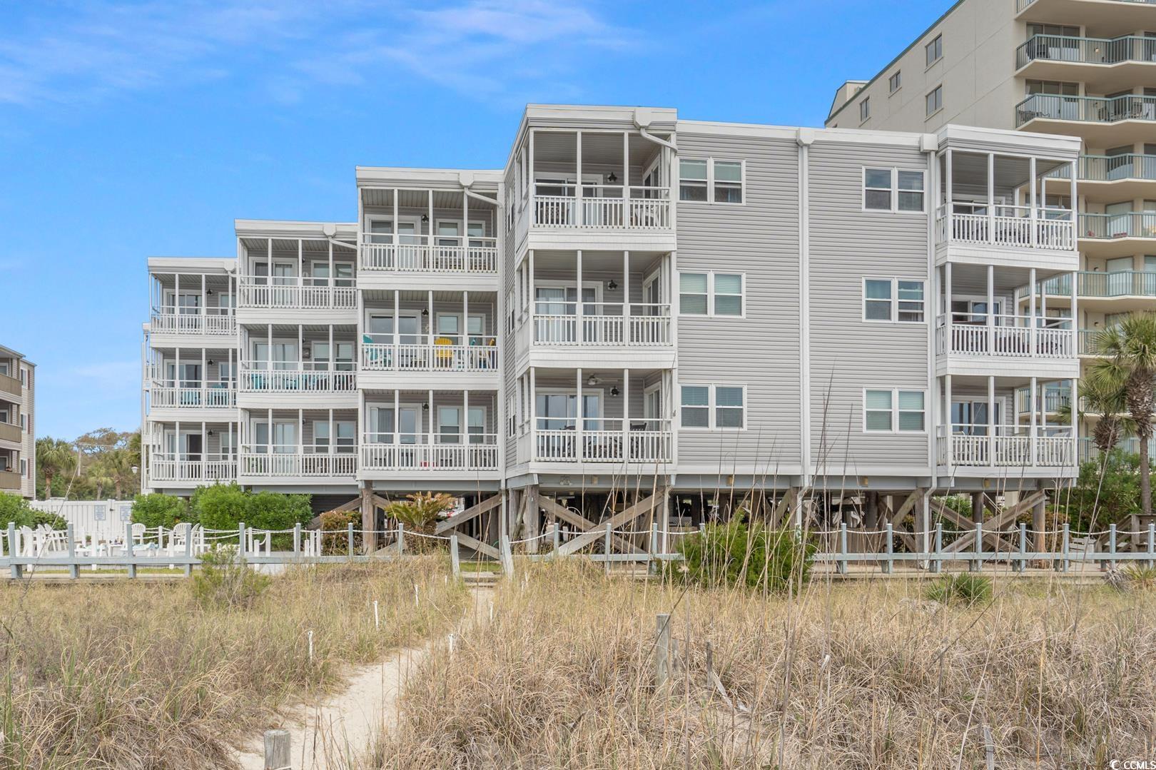 top floor, direct oceanfront, nicely furnished, corner unit in windsong in the windy hill section of north myrtle beach. this unit has been completely renovated and updated with so much to offer including lvp flooring, flat ceilings, granite countertops, remodeled (open) kitchen, subway tile backsplash, nice fixtures, nice window treatments, replaced exterior windows and doors, complete master bath remodel, walk-in tiled shower, new vanities and toilets, laundry room, and access to oceanfront balcony from the primary bedroom and living room. this amazing unit has tremendous oceanfront and coastline views and is fully equipped ready to move into, rent, or use as a second home. complex has pool and an oceanfront sun deck.