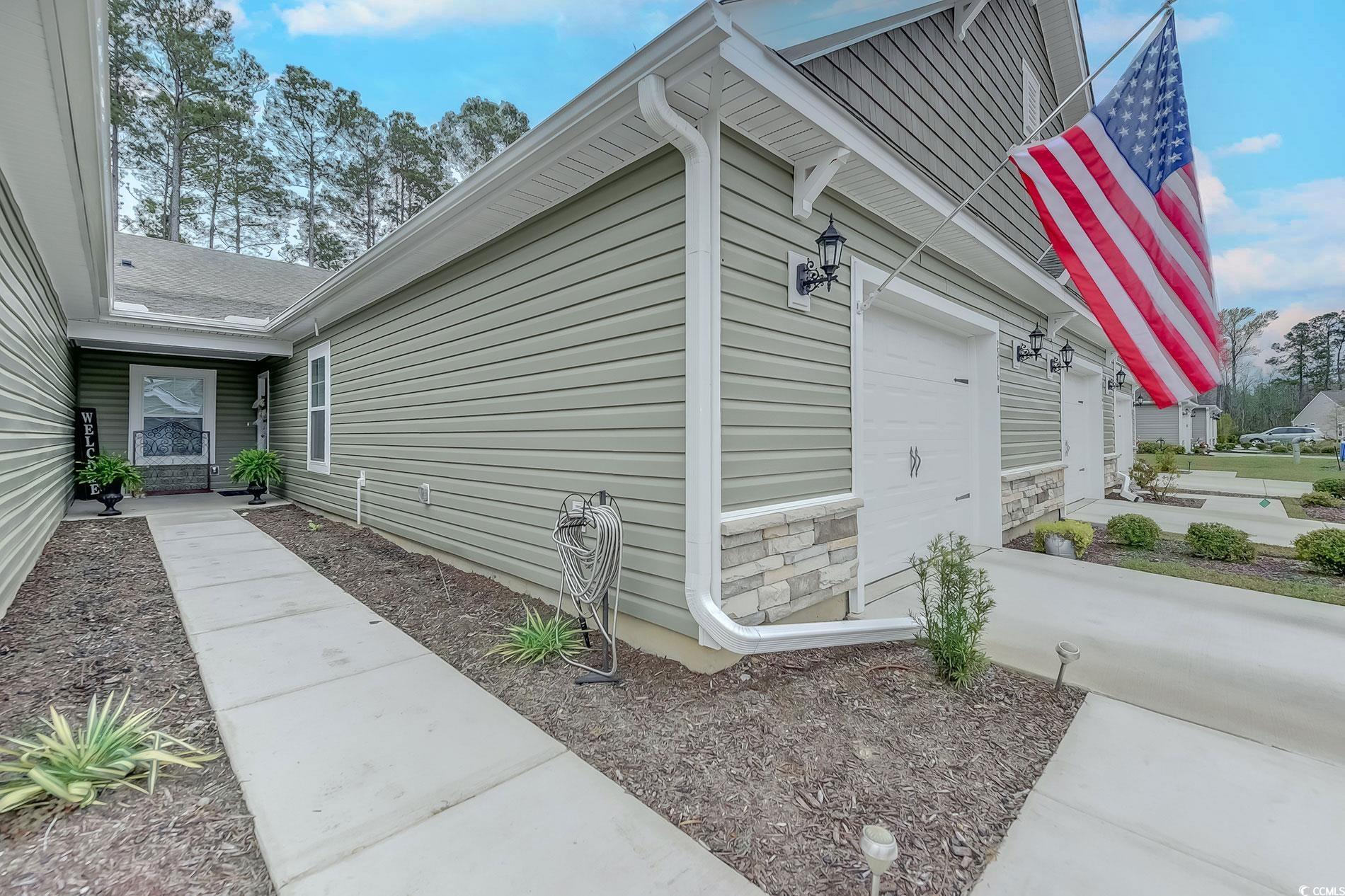 welcome to this one level condo located 6 miles from the beach.  as you enter the kitchen, you're greeted by a large island, granite countertops, a coffee bar and lots of storage including two pantries.  the dining area has a beautiful light fixture and joins the living room which features vaulted ceiling.  from there you can see the spacious outdoor space with private fencing on each side.  the master bedroom has tray ceilings and large walk in closet in the bathroom.  plantation shutters have been installed throughout.  the garage is oversized and gives you tons of extra space along attic storage with pull down stairs for easy access.  the amentities include clubhouse, pool, fitness center and playground.  come take a look!