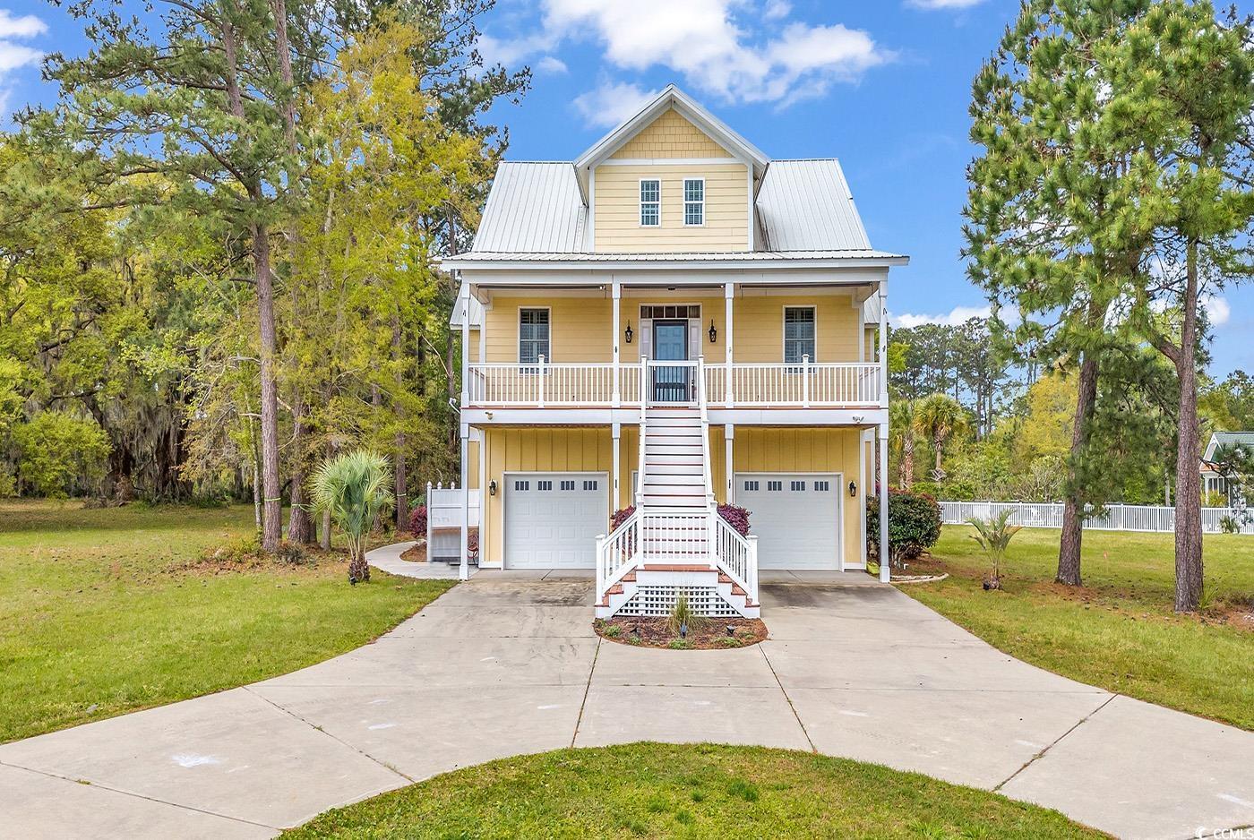 this excellently crafted four-bedroom residence is nestled within a stunning waterfront community adorned with majestic live oak trees. within walking distance lies a convenient day/fishing dock featuring a gazebo, as well as a community clubhouse complete with a pool. step onto the front porch to behold sweeping vistas of the marshland and the picturesque winyah bay/intracoastal waterway. the interior boasts luxurious touches, including granite countertops in both the kitchen and bathrooms, complemented by stylish backsplashes. tiled showers, stainless steel appliances, exquisite cabinetry, plantation shutters, a cozy fireplace, and distinctive hardwood flooring further enhance the home's appeal. the lower level, complete with its own bar kitchen and half bath, offers versatile space ideal great for man cave or great for a home theater due to the surround sound already ready for hookup. practicality meets sophistication with epoxy-coated garage and workshop areas for effortless maintenance. the exterior features durable hardi-plank siding, a metal roof, and composite decking, ensuring minimal upkeep. located a short drive from the pristine beaches of pawleys and litchfield, with downtown charleston just over an hour away, this property also provides easy access to nearby boat landings and marinas. indulge in the rich heritage of historic downtown georgetown, with its array of dining, cultural, and shopping experiences. don't miss out on this exceptional opportunity to own this stunning property. open house this friday 12-3. come take a tour of this stunning property yourself.