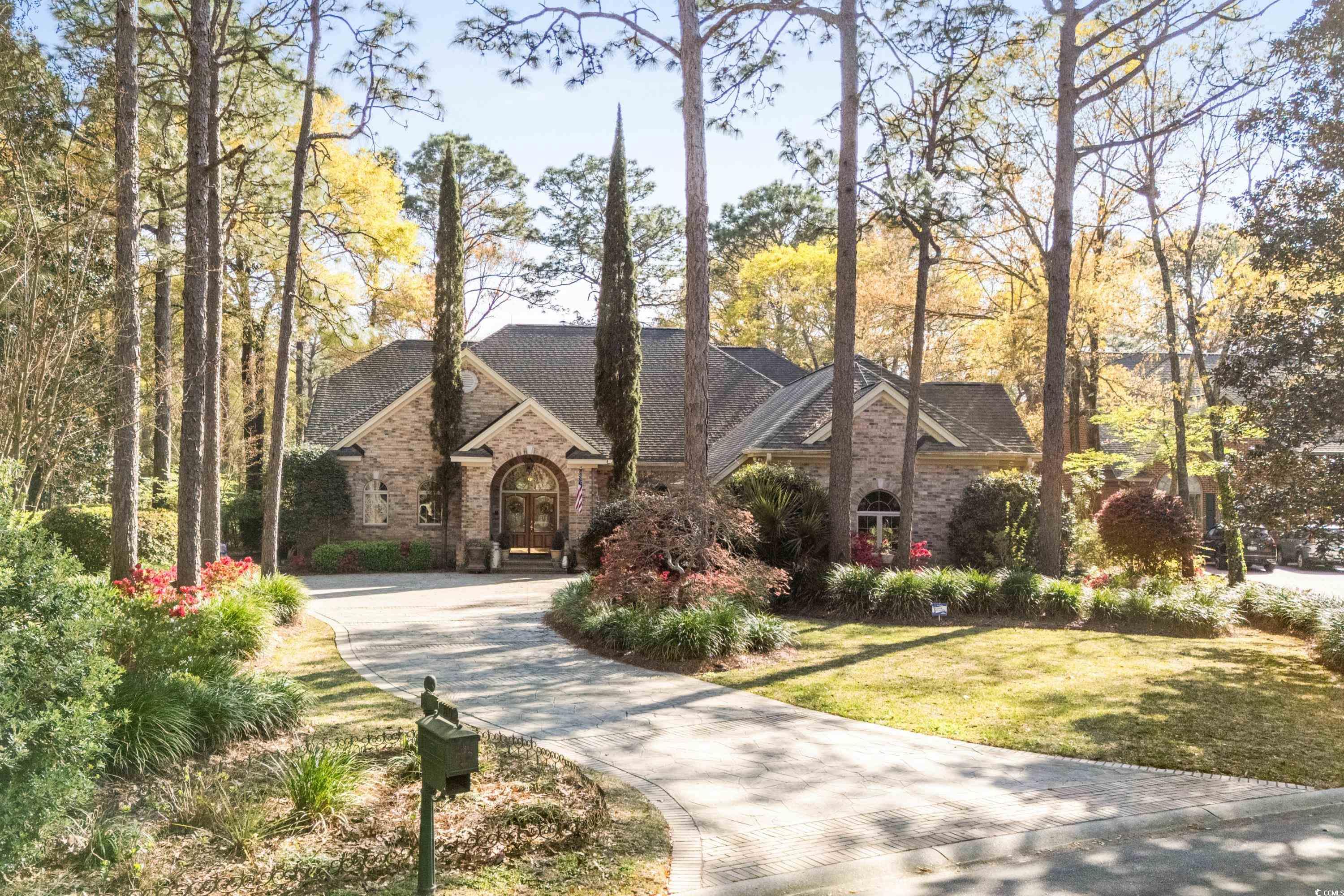 discover the essence of mediterranean elegance in this meticulously designed home, where every detail reflects a commitment to quality and craftsmanship. upon entering, you are greeted by an array of hand-crafted finishes including crown moldings, hand-painted tray ceilings, skylights, and a harmonious blend of hardwood and tile flooring. the living space, anchored by a gas fireplace with a stone mantle, features french doors and half-round windows leading to the remarkable carolina room. this space, enhanced by transom windows, overlooks a serene outdoor sanctuary complete with fountains and a waterfall koi pond, offering a perfect blend of indoor and outdoor living.  the seamless flow continues into the gourmet kitchen, a dream for any culinary enthusiast, featuring light wood cabinets contrasted with dark granite countertops, stainless steel appliances, and a breakfast nook. adjacent to the kitchen, the family room boasts a deep tray ceiling with a stunning mural, a second gas fireplace, and custom built-ins. the home's layout is ideal for entertaining, with the carolina room providing views of the beautifully landscaped garden and the prestigious heritage golf course.  the master suite, conveniently located on the first floor, offers spacious luxury with designer tray ceilings, a lavish bath with double vanities, a whirlpool tub, a large walk-in shower, and an expansive closet. an additional first-floor bedroom serves as a versatile office space. upstairs, guests will appreciate the privacy of two additional bedrooms, each with ample closet space and private baths. the home's thoughtful design also includes a bonus room with a full bath and an oversized garage with a work area, ensuring that this home is not just a residence, but a retreat for those who appreciate the finer things in life.