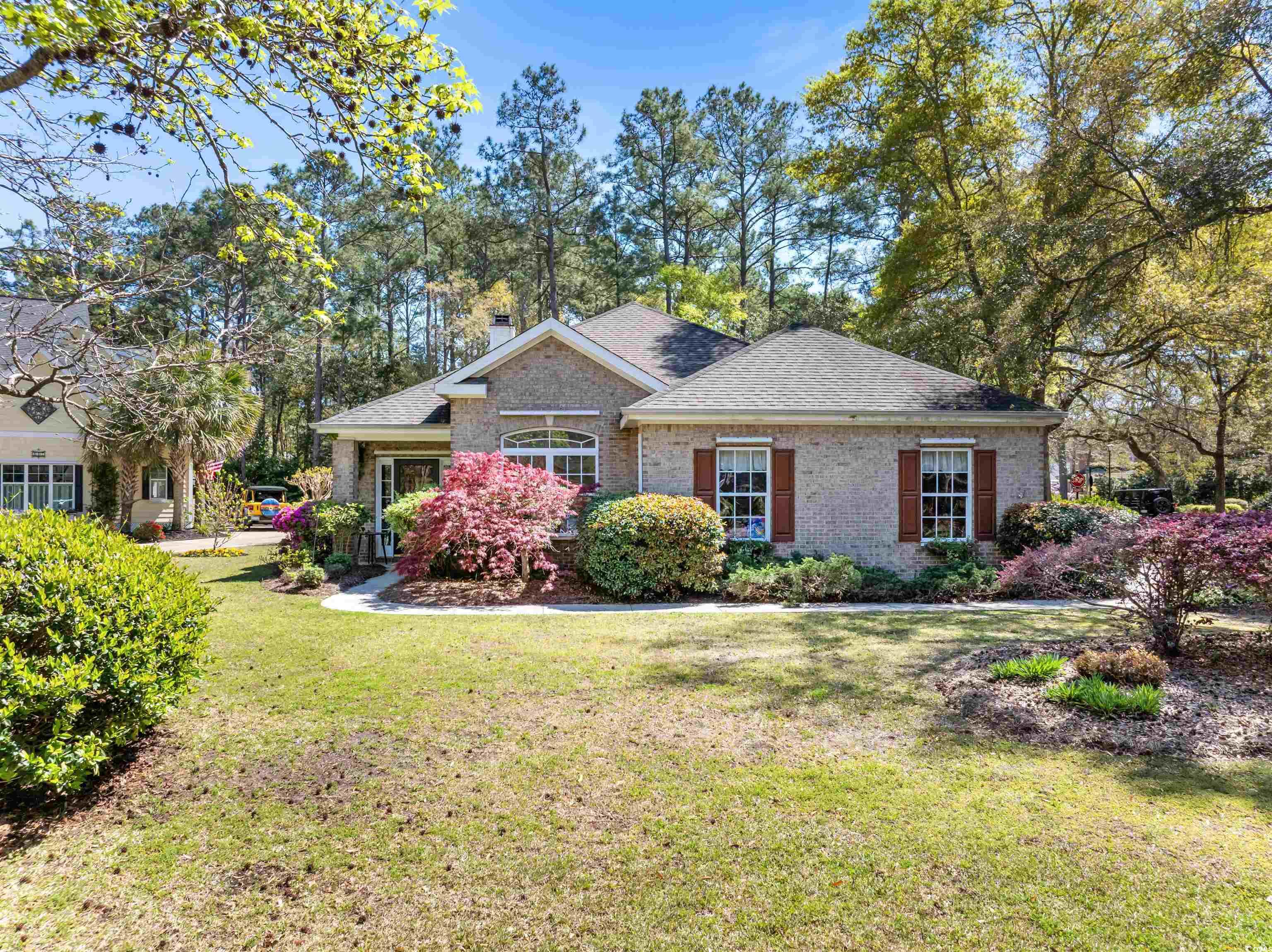 beautiful home in pawleys plantation! this 4 bedroom, 2 bathroom home features a very open, split bedroom floor plan. the formal dining room, living room, great room and kitchen all flow into each other with a fireplace as a centerpiece of the home. enjoy a cup of coffee on the peaceful screened in porch with views of the well maintained yard. this yard boasts beautiful flowers and plantings for a serene feel. the spacious garage can easily fit two cars. pawleys plantation is a pristine, gated community that features a premier jack nicklaus course. the gorgeous trees throughout give this a community a very private feel, although it is nearby to all the great restaurants and activities  pawleys island has to offer. don't miss out on this wonderful opportunity to own a home in pawleys plantation!