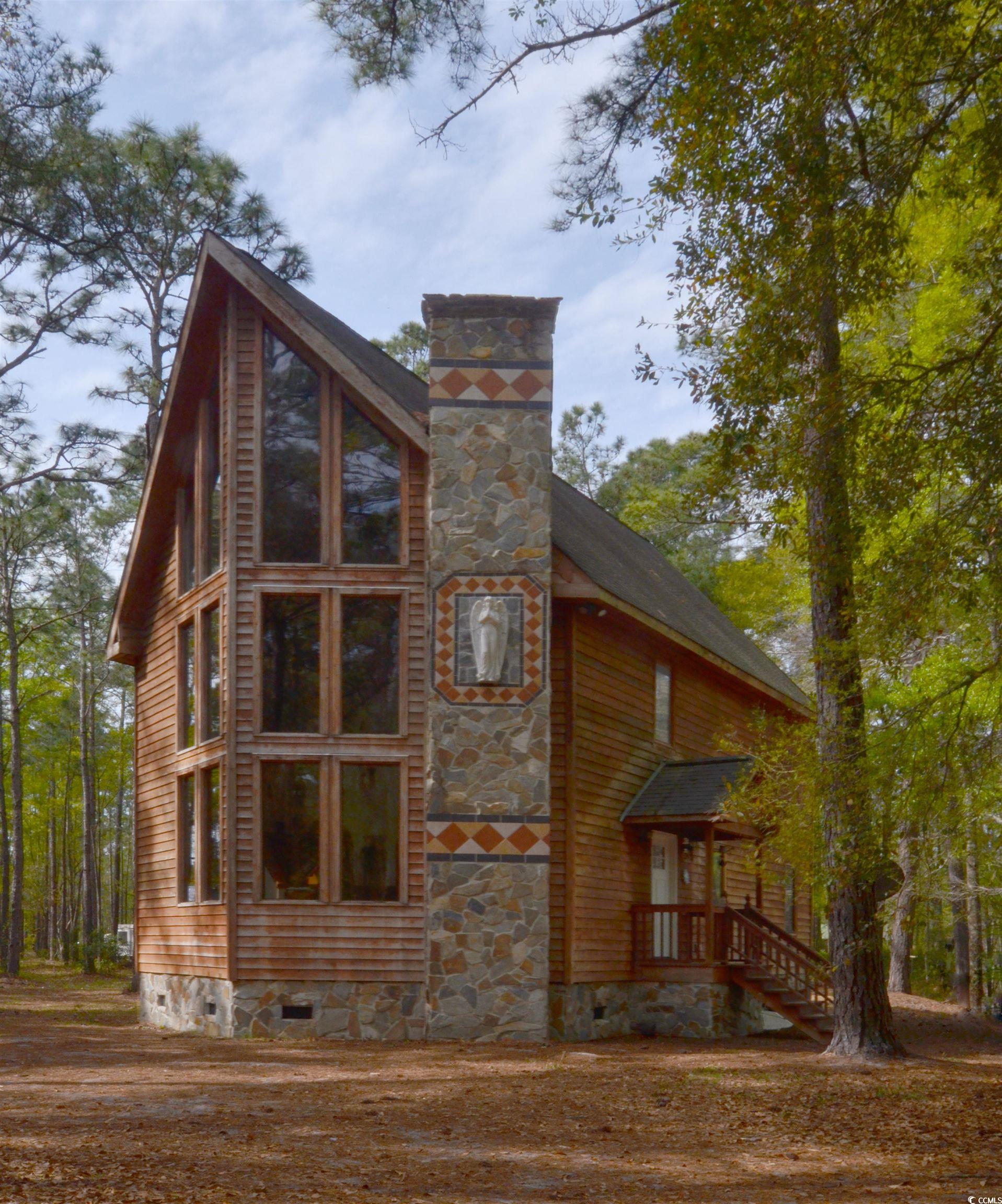 check out this unique gem in the woods off of south island rd, only a mile and a half from the intracoastal waterway and ten minutes from georgetown. this four bedroom two bath home is loaded with character and unique design elements that make it stand out above the rest. with intricate tilework throughout, massive glass windows, and a stone fireplace that stretches from floor to ceiling in the vaulted living space, it is easy to see the high quality craftsmanship that went into this custom home. featuring a formal dining room, full laundry room, and beautiful a bathroom the well thought out floorplan downstairs allows for great flow and ample space without sacrificing charm. upstairs you will find a full floor master suite with an amazing bathroom, walk in closet, and a large bedroom complete with a private balcony. there is a large enclosed loft on the third floor which has great potential to be a playroom or office as well as a bedroom. sitting on more than an acre with no hoa, this property has plenty of room to spread out and enjoy the quiet life while still being close to the restaurants and shops of front street or the picturesque village of mcclellanville. south island ferry boat landing is under a mile and a half from the front door making this home one of the best centrally located properties for boating in the county, with access to the santee delta and winyah bay at your doorstep as well as north inlet and cape romain under a twenty minute boat ride away. don't miss this opportunity to be away from it all while being in the middle of it all!