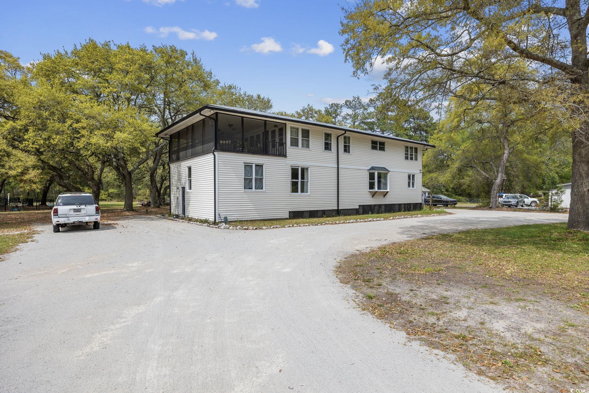 ask about the seller's buying incentive - welcome to murrells inlet's most charming home with no hoa that sits on a little over one acre of land. the second level of the home is the original build from 1958 consisting of knotty pine framing. unique to this home is knotty pine walls, ceilings, floors, doors, cabinets, and trim. enjoy a nice day on the upstairs screened in porch and feel the inlet breeze. the second level was relocated to this land in 1990 by an unmatched engineering cradle system. enter into the beautifully renovated (2020) bottom floor by its private entrance. new siding, metal roof, ac units, and back porch were all apart of the renovation as well. both floors have a highly desired natural lit, open floor plan. upstairs is 2 bedrooms and 1.5 bathrooms and the bottom floor is also 2 bedrooms and 1.5 bathrooms. the perfect spot for entertaining with the expansive driveway and backyard that can hold boats, trailers and/or rvs. nothing like this homes curb appeal with all the stunning oak trees on this lot. to add onto all that this home already has to offer is the workshop with a commercial kitchen and full bathroom with a 50 amp service on the exterior. just a mile ride on the golf cart to the locals beloved marshwalk and wacca wache marina. don't miss out on this amazing opportunity.