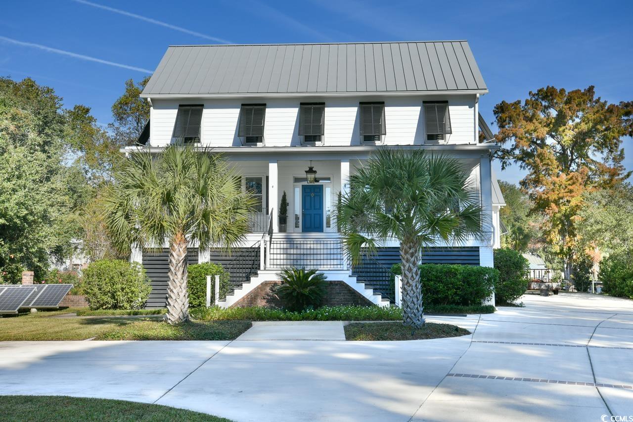 exceptional low country raised farm house on a canal in the much sought-after, beautiful neighborhood of waverly mills in historic pawleys island, sc.  this 5 bedroom, 5.5 bath home was built in 2003 and completely renovated in 2021.   welcome home to 125 angel oak drive.  you enter from the substantial front porch to the wide central hall flanked by an inviting living room and home office to your left.  your right is the impeccable formal dining room.  each room has a fireplace with lovely built-in book cases and glass paned pocket doors.    the spacious cooks kitchen features all stainless appliances including a 6 burner gas range, built in wall oven and microwave, and sub zero refrigerator.  the generous island is full of storage and has a built-in ice maker for all your entertaining needs.  the kitchen and formal dining rooms are connected by a beautiful butlers pantry loaded with storage.  there is also a kitchen utility room with sink and room for your extra refrigerator which makes serving large dinner parties a breeze.  the kitchen and main family living area are all open and inviting.  gather around the fireplace or enjoy a cocktail on the large wrap around porch overlooking the dock with boat lift on waverly creek that will take you directly out to the waccamaw river.  this is a 16,000 lb lift equipped to handle up to a 30ft center console boat.   the owner's suite is a dream come true with his and hers custom closets, large private bath including a dynamic far infrared sauna, and separate laundry room.  make your way up the extra wide stairway or take the elevator to the third floor to find a charming sitting area between two identical en-suite bedrooms.  as you head down the hall to the third en-suite guest room, you pass the third floor home office as well as the convenient third floor laundry room.  the home has hardwood floors throughout and tons of storage and closet space.    how you will use the ground floor at 125 angel oak is up to you.  there is a separate garage that leads into two connected rooms with a bath that could be a mother-in-law suite, extra guest space, home business or entertainment area.  so many possibilities!  the main two garage spaces lead to an extra large storage space and work shop that is every do-it-yourselfers dream.    the construction of 125 angel oak is unique.  it is built to withstand major storms.  it's poured icf concrete exterior walls are designed to withstand winds up to 250 mph.  the sprayed foam insulation under the low maintenance metal roof, including the large attic storage space keeps the house cooler in the summer and warmer in the winter.  solar panels with new converter further contribute to the extra low utility bills.   125 angel oak is a unique property.  it was designed to be a practical, safe and economical home to maintain while offering a beautiful and comfortably luxurious home in which to live your best life now.  if you've been waiting for your dream home, this is it!