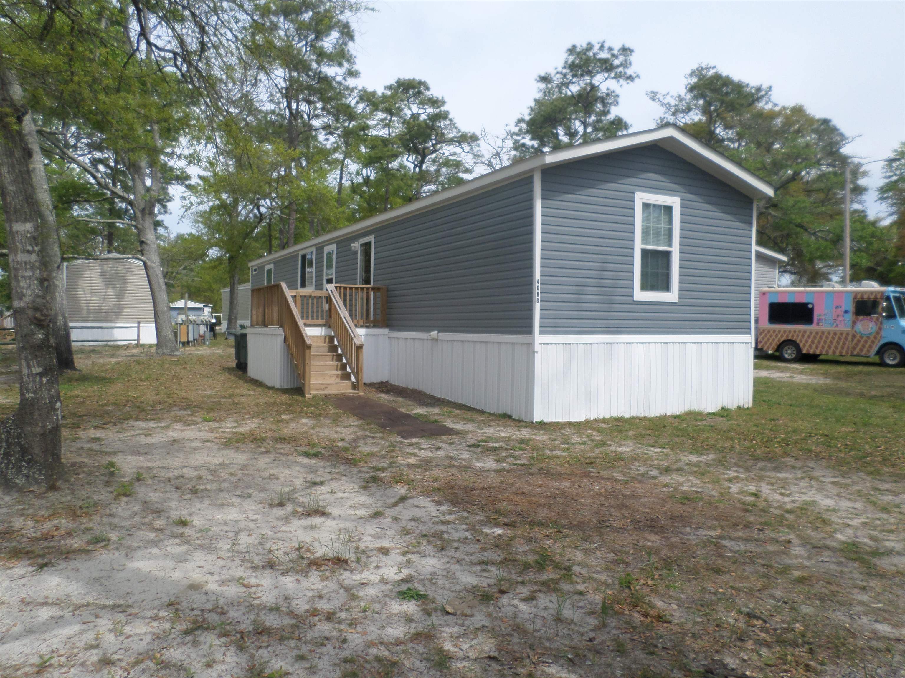 price improvement on this lovely 3 bedroom 2 bath 2023 fleetwood inspiration manufactured home with all furnishings, appliances and decks is set up in the sought after leased land community of creekside north myrtle beach, sc. the large leased lot is shaded by beautiful trees and has plenty of room for additions such as a storage building or fencing.  this home is top of the line with sheetrock walls, ceiling fans, upgraded cabinetry and hardware, island bar, large master bedroom with walk in closet and dual porcelain master bathroom sinks.  the linoleum flooring is easily maintained and flows beautifully throughout the home.  the furniture and color patterns catch your eyes as you enter the home and will remain as a part of the sale.  the community offers a large swimming pool for residents and guests, onsite mail boxes, clubhouse with playground and picnic area, seating benches on the marsh of cherry grove. 1000 gallons of water, trash pick up and common area maintenance is included in the lot leasing fee. the home may be used as a primary residence or vacation property. it has everything you will need to move right in including new bedroom sets, kitchen supplies including utensils, dishes, pots, coffee makers, blender, sheets, towels, etc.   come grab your piece of paradise in a well maintained community.  creekside is close to the intracoastal waterway and only minutes to the beautiful atlantic ocean in the cherry grove section of north myrtle beach, sc. golf carts, motorcycles, and pets are allowed and must be approved by management upon land leasing. call for further details and to view this immaculately maintained home.  a must see today.
