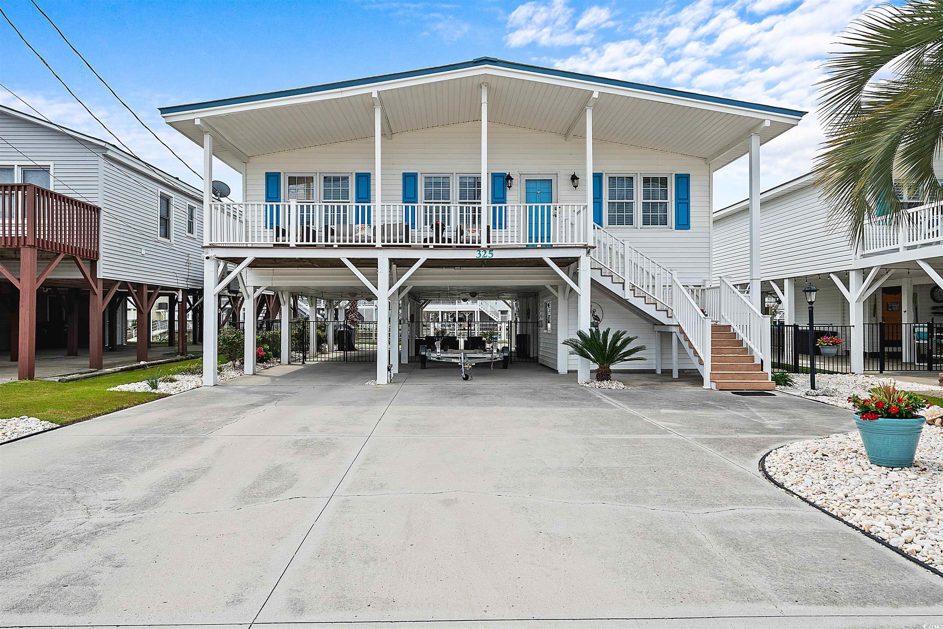 this is the beach house you have been looking for. located in the very desirable cherry grove area of north myrtle beach sc. this is a channel home raised beach house right on the inlet channel of 58th ave. n. it's a 4 br 2.5ba home with a beautiful manicured yard. the fully furnished home has been fully renovated from the moment you step on the front steps, the steps and  front porch area is made out of trex for it's beauty and its low maintenance and the roof is metal for a great  look and durability. when you walk thru the front door you are greeted by an open floor concept with a raised beam ceiling, oak laminate hardwood floors throughout the home with the exception of the bathrooms and utility rooms downstairs. the kitchen features granite counter tops, tiled back splash, custom cabinets with a breakfast bar/island right in the middle. the kitchen features a side by side refrigerator, smooth top stove and oven, microwave and dish washer. there are 4 large bedrooms and 2 baths, one with a shower and 1 with a tub/shower combo. the highlight of the home is the back porch/deck area that overlooks the channel and the backyard. the backyard features a manicured turf area, a sea wall and a jet ski dock. the jet skis do not convey but, can be negoiated.  the downstairs under the home is a perfect place for entertaining on those cool spring and hot summer evenings. it features outdoor furniture, a tv, a 12x15 storage area for all your beach gear, a kitchen area with a sink and a microwave and a half bath. this beach home has it all and is waiting on the new owners to love it as much as the current owners have. come check it out.