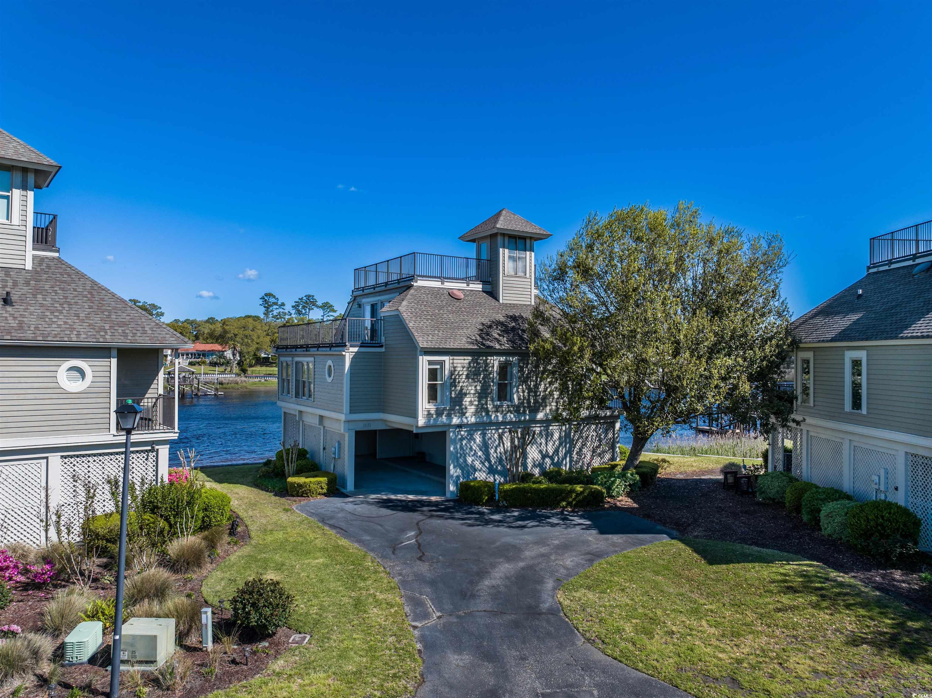 step into luxurious waterfront living in the prestigious harborloft section of the tidewater community in north myrtle beach, sc. nestled along the picturesque intracoastal waterway, this exquisite home offers a rare opportunity to embrace the epitome of coastal elegance. as you enter this gated golf community, a sense of tranquility greets you, setting the stage for the extraordinary lifestyle that awaits. boasting unparalleled views of the shimmering waterway, this residence is a sanctuary of tranquility and sophistication. elegance abounds within the walls of this meticulously designed home. with meticulous attention to detail, the interior seamlessly blends timeless charm with modern conveniences.  the elevator gives this multilevel home convenient access from the ground level. indulge in culinary delights in the open kitchen, with plenty of room to entertain guest. gather with loved ones in the spacious living area, illuminated by natural light pouring in from panoramic windows that frame the breathtaking water views. step outside to your private oasis, where outdoor living reaches new heights. the expansive deck is the perfect setting for al fresco dining, entertaining guests, or simply basking in the serenity of the waterfront setting. take a leisurely stroll down to your private dock, where you can embark on boating adventures or simply soak in the coastal ambiance. don't miss your chance to experience the pinnacle of coastal living in this extraordinary home on the intracoastal waterway. schedule your private tour today and prepare to embark on a lifestyle beyond compare.