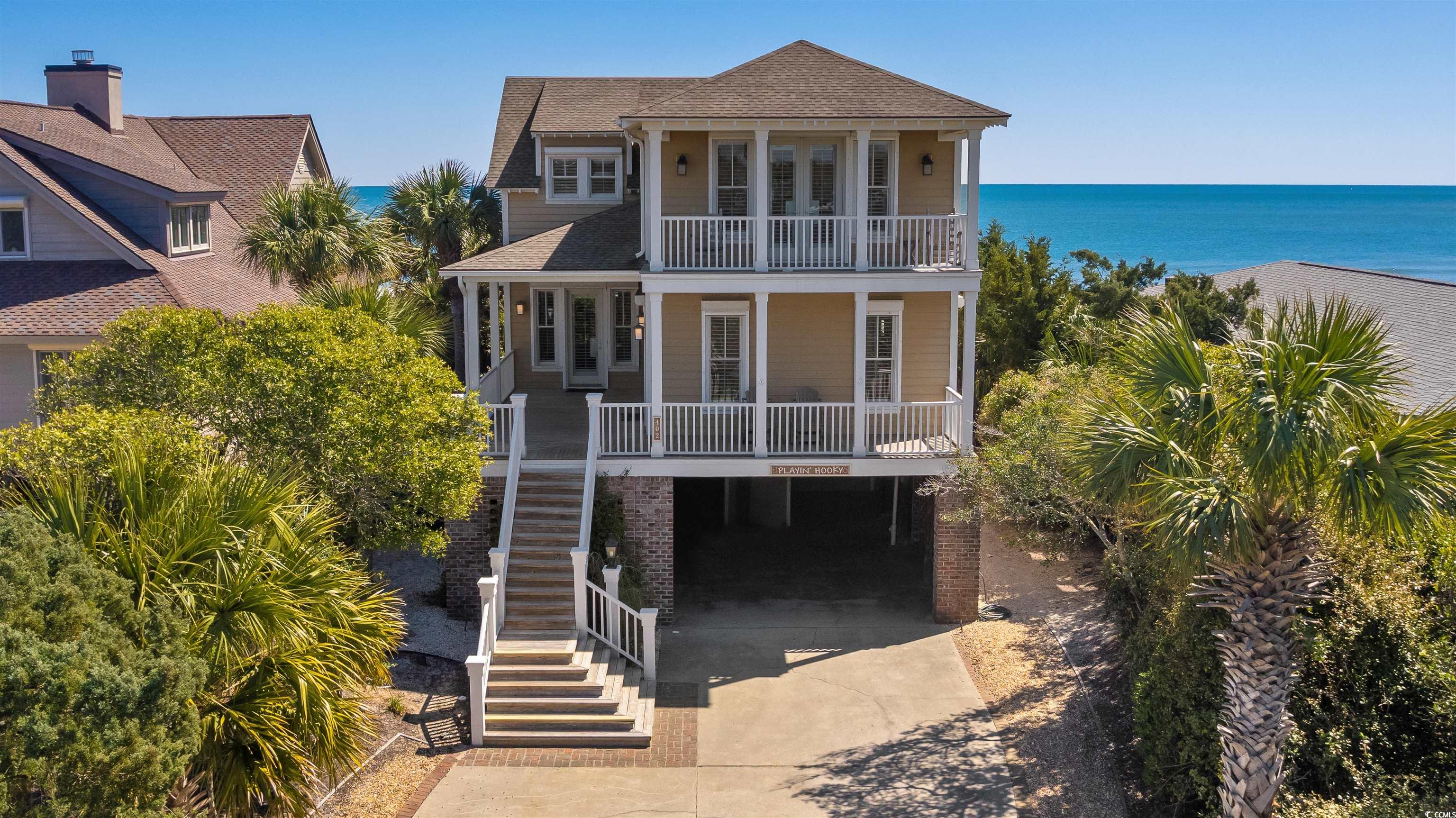 imagine waking up to the sounds of the ocean just outside your door. or enjoying a cool beverage watching the evening sunset over the pawleys island creek. this is the beauty of 402 myrtle avenue. this home sits on one of the highest points in pawleys island making it a safe haven from storms. porches on the front and rear of home provide ocean and creek views. inside you will find an open concept, large family living space for entertaining all your family and friends. newly installed stainless steel appliances compliment the chef in the family ready to serve anyone at the breakfast bar with 4 seats or long dining room table that seats 14. built-in buffet serving space makes family get-togethers easy to plan. living room has three cozy sofas with reclining end seats. tv is mounted over the new gas log fireplace. screened porch with picnic table just outside the family room and also an open air porch. boardwalk leading to the ocean has a shower for sandy feet, and a seating area with a flagpole for close views of the beach and ocean. a doggy boardwalk is off the open porch and leads down to a fenced-in area underneath the porch. also located on the first floor is a bedroom with views of the marsh and creek, full bathroom, laundry room with maytag washer and dryer and double utility sink, two 50 gallon hot water tanks, and a half bath. there is an elevator that opens on all three levels. stairs lead underneath the house. another set of stairs takes you upstairs to four more generously sized bedrooms. a loft area with sofa and table can be used for office space or extra sleeping space. one upstairs bedroom has french doors leading out to a porch overlooking the creek and marsh. two more bedrooms have built-in sleeping spaces in the dormer in addition to the beds already in the rooms. plenty of closet space for storage. the master bedroom overlooks the ocean and has its own private porch for enjoying the cool ocean breezes. the master bath has a walk-in closet and another closet. also in the master bath are a double vanity, linen cabinet, separate whirlpool tub, and stand alone shower. underneath the house on the ground level, are two enclosed showers, toilet and fish sink. three storage closets are also on the ground level as well as an extra refrigerator to store extra drinks and food. elevator access on the ground level is very helpful for getting not only your loved ones, but also your grocery haul upstairs. the boardwalk to the beach is wheelchair accessible from the ground level. take a walk across the street to the newly constructed, private dock and enjoy the relaxing views of pawleys creek. you might even see friends riding by in a jon boat fishing or just cruising along. this home is located in the historic district of pawleys island and is perfectly situated along the annual 4th of july parade route. pawleys island is home to many award winning golf courses, fine and casual dining, shops and boutiques, art galleries and river access. myrtle beach is 30 miles to the north. charleston is 60 miles to the south.  take advantage of this once-in-a-lifetime opportunity to be able to purchase a spacious, strong, beautiful oceanfront home along the south carolina coast. call us today to come visit this home and begin enjoying your life in pawleys island, sc.