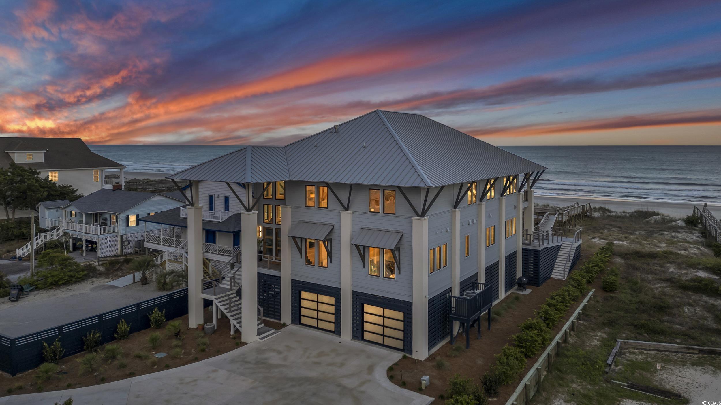 welcome to 554 parker dr., your gateway to luxury oceanfront living at north litchfield beach! this custom-built coastal sanctuary beckons with its unparalleled sophistication and an array of amenities designed to elevate your lifestyle.  designed by catalyst architects and built by bec construction, a well-known custom home builder with over 35 years of experience in the area, this amazing home sits on an oversize beachfront lot with panoramic views of the atlantic ocean.  with five bedrooms, seven and a half bathrooms, and almost 5300 heated sf, the home offers ample space for relaxation and entertainment, making it perfect for hosting gatherings with family and friends. entertain with ease in the expansive gourmet kitchen, featuring high-end wolf and sub-zero appliances and a convenient butler's kitchen with additional prep sink, refrigerator and dishwasher for seamless culinary adventures. indulge in the tranquility of your own personal haven as each bedroom features ensuite bathrooms for maximum privacy and comfort. experience the epitome of convenience with lutron automated shades gracing every window. enjoy the warmth and character of the modern gas fireplaces, one on the main level and the other in the upstairs living area. step onto the spacious porches and savor breathtaking sunrises year-round. the owner's suite offers two separate bathrooms and walk-in closets, ensuring a lavish experience tailored to your desires. additional features include, built in beverage fridge and zephyr ventilation in kitchen, ipe decking on all decks and walkway to beach, handicap friendly features throughout, whole house generator, upstairs porch warmed by infrared heaters, mudroom/laundry room on main level and additional washer/dryer upstairs next to owner’s suite for convenience, elevator, outdoor beach shower and generous room for parking and storage underneath, too many luxury features to list! one bedroom is set up also as a play zone with rock climbing and rope net system bringing adventure to children of all ages!  another bedroom is set up with murphy bed so that it can be used as a home office. the home is being offered fully furnished with designer interior and high end tv and audio systems. a custom built detached garage is also included with over 1000 sf of heated space above with a half bath.  currently set up as a workshop for the carpentry or hobby enthusiast, but could be great space for rec room/media room. 554 parker dr. was designed with the utmost protection from the elements in mind. in addition to north litchfield beach being known for deep dunes and some of the finest oceanfront stability on the sc coast, the homesite was raised an additional seven feet, bringing the building pad grade up to fourteen feet above sea level.  the beach walkway was constructed with treated pilings instead of dimensional lumber, providing extra strength and integrity to the structure. located in the highly desirable north litchfield beach, this residence offers more than just a home; it presents an unparalleled lifestyle. don’t miss this opportunity to secure your family’s legacy at the beach!