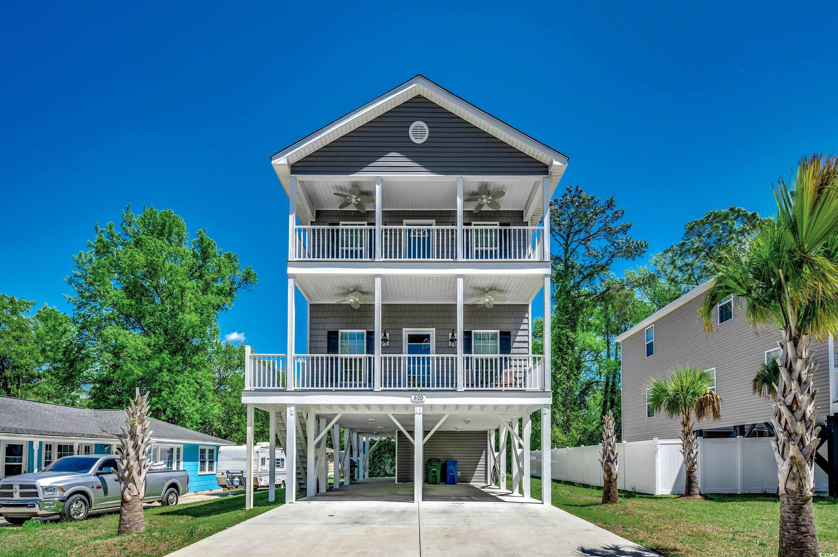 nestled east of 17 in the serene community of surfside beach, this exceptional raised beach house epitomizes coastal luxury and convenience. just a short stroll or golf cart ride away from the sandy shores of the atlantic ocean and iconic surfside pier, this home offers unparalleled access to a beach lifestyle. boasting four bedrooms and four and a half bathrooms, including primary bedroom suites on both levels, a third bedroom with its own ensuite bath, and a 4th bedroom with access to a 4th full bath, this residence provides ample space for comfort and privacy. the chef's kitchen is a culinary haven, equipped with granite countertops, stainless steel appliances, soft-close cabinets and is seamlessly integrated into the dining area and great room for the ultimate in open concept living. lvt flooring runs throughout the home's main living areas and hallways, complemented by ceramic tile in the bathrooms, laundry room and upstairs storage room. this like-new meticulously maintained beach retreat has only been used as a second home and is in pristine condition. abundant storage throughout the home including large walk-in closets in three of the bedrooms, a spacious storage room on the top floor and an impressive storage room located on the ground level ensure a clutter-free environment and plenty of room for all of your beach and golf gear. outside, expansive covered front porches on both levels invite leisurely relaxation for that morning cup of coffee, reading your favorite book or just enjoying the company of family and friends. the tranquil backyard offers ample space for outdoor gatherings and the potential for a pool. with parking for up to 8 cars, this thoughtfully designed home embodies the essence of beach-style living, offering both comfort and convenience in an idyllic coastal setting. in surfside beach, you will be within minutes of many local restaurants, beaches, golf, shopping and the famous murrells inlet marshwalk. come and tour this beauty today.